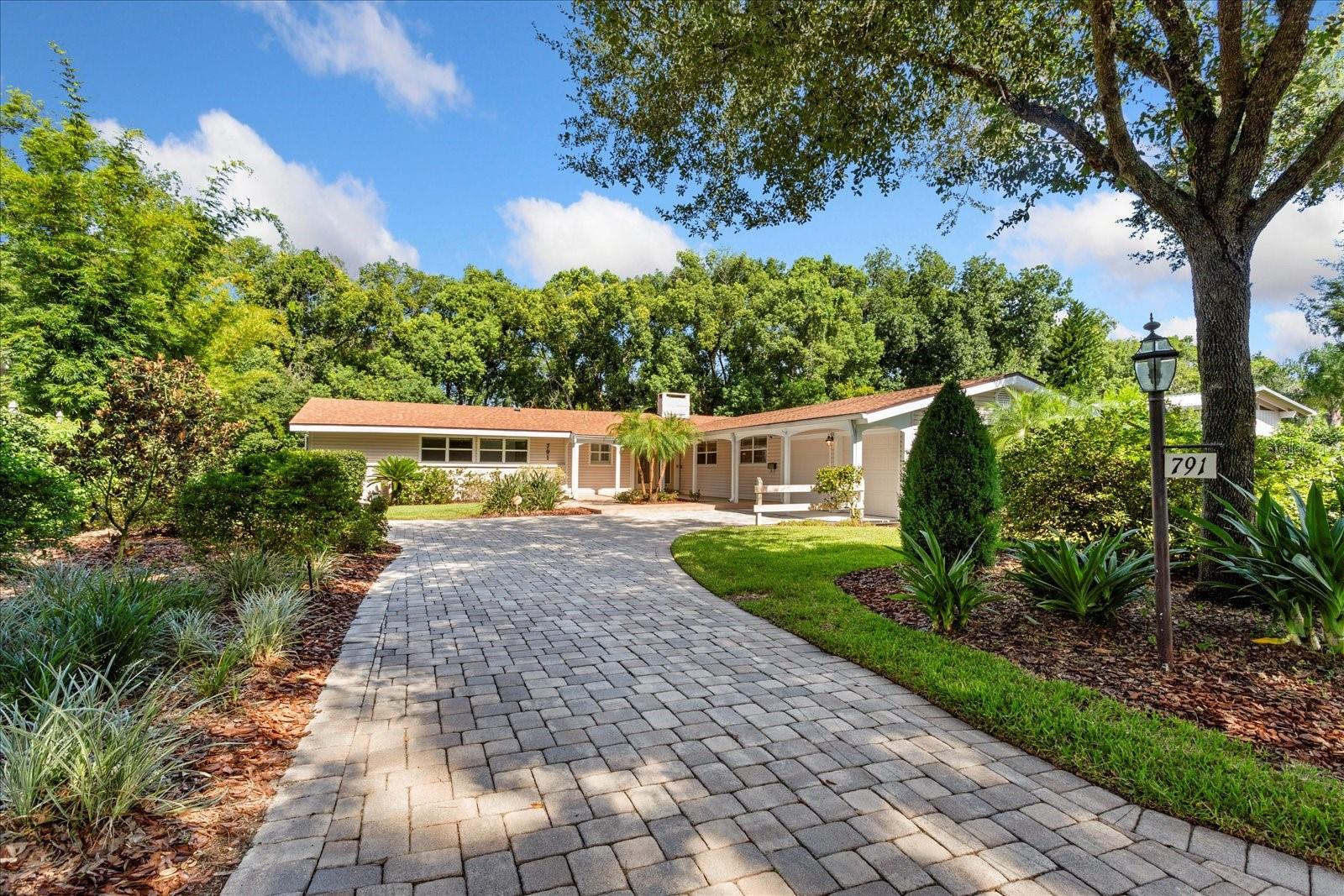 Discover a rare opportunity in Dommerich Woods, a distinguished and established Maitland neighborhood celebrated for its rich heritage. Situated on .33 acre of lushly landscaped grounds, this remarkable property welcomes with paver drive and enjoys a tranquil setting along a
peaceful creek connecting Lake Minnehaha and Lake of the Woods - creating an atmosphere of natural elegance and privacy.
Re-roofed in 2023, this expansive 5 bedroom, 3 1/2 bath residence offers 4,144 HSF, and WHOLE HOUSE WATER SOFTNER, showcases a versatile TWO-LEVEL design, perfectly suited for refined living and gracious entertaining. The main level opens with a foyer leading into a bright, open living and dining area, where CEILING FANS throughout the main level add comfort and elegance. From here, step out onto the COVERED UPPER DECK with sweeping views of the SCREENED POOL, TROPICAL GARDEN, and serene backyard retreat - an ideal setting for morning coffee or evening gatherings.
At the heart of the home, the GOURMET KITCHEN blends style and functionality with SOLID WOOD CABINETRY, a built-in WINE REFRIGERATOR and WINE RACK, granite countertops, and a CENTER ISLAND with SEATING, and REVERSE OSMOSIS WATER SYSTEM under the DOUBLE SINK. The adjacent laundry room offers exceptional storage, keeping household essentials organized. For added convenience , a two-car garage with built-in cabinets and workshop area, adjoins the spacious laundry room that has granite counters and washer and dryer. Also on the main level , adjacent to the primary bedroom with en-suite bath, a bedroom has been thoughtfully converted into a large closet featuring a CUSTOM CLOSET system, providing abundant space for wardrobe organization.
Both levels feature inviting WOOD-BURNING FIREPLACES that add ambiance to the living spaces. On the lower level, a spacious family room, kitchenette, study/library/office, two bedrooms, full bath and half bath provide the perfect complement to easy living. Along the
hallway, built-in wood shelving creates a refined showcase for books, art, or personal collections. While one bedroom includes a custom built
in desk- ideal for work or study, a second bedroom adds flexibility for creative projects. This level opens onto the screened pool and patio area, designed for seamless indoor-outdoor living. Outside, tropical plantings, METERED IRRIGATION, and a winding private walkway leads along the soft murmur of the BORDERING CREEK. An added bonus is the storage room located below the kitchen which is approximately 375 sq.ft. Whether hosting guests or enjoying a quiet evening, this private oasis offers the ultimate backdrop for relaxed Florida living.
Enjoy the opportunity to join the Dommerich Beach Civic Association with membership options including access to a private picnic area, boat ramp, canoe and kayak storage, and unforgettable evening sunsets. With its rare combination of design, flexible spaces, and an idyllic setting , this residence presents a unique opportunity to experience the very best of Maitland and Central Florida living. All this is convenient to some of Central Florida's finest schools, shopping, restaurants, parks, entertainment, businesses and more!