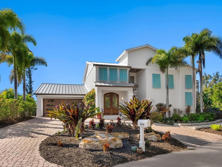 Beautifully private, this exceptional Siesta Key residence delivers the lifestyle discerning island buyers seek. Ideally near the aqua Gulf waters and powdery white sands of Crescent Beach, and moments from the peaceful shoreline of Turtle Beach, this remarkable coastal retreat spans approximately 230 feet of protected boating water and is tucked at end of a quiet, tree-lined street, offering rare privacy and a sense of peaceful seclusion seldom found on the island. This two-story home offers flexible living with three to four bedrooms, six and a half baths, an office or den, and thoughtfully designed indoor-outdoor areas that define relaxed island luxury. A gracious arrival sets the tone as antique wood and glass double entry doors open to a light-filled foyer and formal living room, anchored by a custom electric fireplace and framed by soaring windows. Natural light pours in, highlighting architectural details and creating an immediate sense of warmth and understated sophistication. The heart of the home is a magnificent kitchen designed for entertaining and everyday living, featuring a generous central island that flows seamlessly into the inviting family room with a wood-burning fireplace. Walls of glass throughout dissolve the boundary between indoors and out, creating a seamless connection to the lush, private surroundings. The main level includes a private guest en-suite with direct lanai access, along with a unique screened atrium, an inviting space for alfresco dining, sunning or quiet relaxation. An adjacent flex room easily serves as an office, studio or additional guest suite, offering versatility for today’s evolving lifestyles. Upstairs, a graceful, curved staircase leads to another en-suite bedroom, a full bath adjacent to the office or flex space, and owner’s retreat. The primary suite is a sanctuary, complete with separate spa-inspired baths, expansive walk-in closets, and a private sunset terrace overlooking the pool and tranquil canal waters, an ideal setting to unwind at the end of the day. Outdoors, the property transforms into a private waterfront oasis. The lushly landscaped pool area features cascading fountains, while boating enthusiasts will appreciate 230 feet of seawall, a private dock, 7,000-pound boatlift, kayak lift and separate fishing pier, all on deep, protected water with quick access to Sarasota Bay and the Intracoastal Waterway. Notably, the property experienced no damage or flooding during the 2024 storms, according to the owners, offering valuable peace of mind alongside its exceptional setting. Enjoy effortless access to the beach, nearby restaurants and shops, and free island trolley. When you’re ready to venture beyond the island, downtown Sarasota is just minutes away over the south bridge, offering world-class dining, arts and culture, including The Ringling, Van Wezel Performing Arts Hall, St. Armands Circle and vibrant Sarasota Farmers Market. This is a rare opportunity to own a storm-resilient waterfront retreat that seamlessly blends privacy, boating access, accessibility and timeless coastal elegance, the best of Siesta Key living.