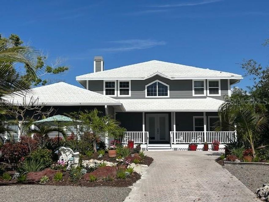 Tranquility abounds as you enter the gates of Sandhamn Place, developed by Peder Wallenberg and named after a quaint fishing village just outside of Stockholm Sweeden. A private canopied road winds through this sanctuary of nine custom designed waterfront homes, all enjoying expansive views of Sarasota Bay. Be among the privileged few that can call Sandhamn Place their home on Longboat Key, with no tear downs to pass and no barnacle encrusted seawalls staring back at you  and no through traffic to tolerate; just 50 square miles of the beautiful bay with only leisurely kayakers & paddleboarders, frolicking dolphins and meandering manatees passing by. Sandhamn Place has its own tennis court and marina with deeded boat slips and is ideally located near the center of Longboat Key, just a short distance from some the island's finest restaurants, shops and conveniences  as well as Durante Park, a 32 acre nature preserve with overhanging mangrove walking trails. The home was designed with Key West in mind and offers a relaxed lifestyle at the end of the cul de sac with its own private observation dock extended out into the bay that can be accessed from the screened lanai and heated pool or from the upstairs deck adjoining the primary ensuite  bedroom  overlooking Sarasota Bay.