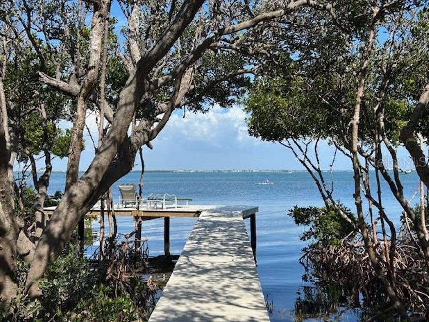 Tranquility abounds as you enter the gates of Sandhamn Place, developed by Peder Wallenberg and named after a quaint fishing village just outside of Stockholm Sweden. A private canopied road winds through this sanctuary of nine custom designed waterfront homes, all enjoying expansive views of Sarasota Bay. Be among the privileged few that can call Sandhamn Place their home on Longboat Key, with no tear downs to pass and no barnacle encrusted seawalls staring back at you  and no through traffic to tolerate; just 50 square miles of the beautiful bay with only leisurely kayakers & paddleboarders, frolicking dolphins and meandering manatees passing by. Sandhamn Place has its own tennis court and marina with deeded boat slips and is ideally located near the center of Longboat Key, just a short distance from some the island's finest restaurants, shops and conveniences  as well as Durante Park, a 32 acre nature preserve with overhanging mangrove walking trails. The home was designed with Key West in mind and offers a relaxed lifestyle at the end of the cul de sac with its own private observation dock extended out into the bay that can be accessed from the screened lanai and heated pool or from the upstairs deck adjoining the primary ensuite  bedroom  overlooking Sarasota Bay.