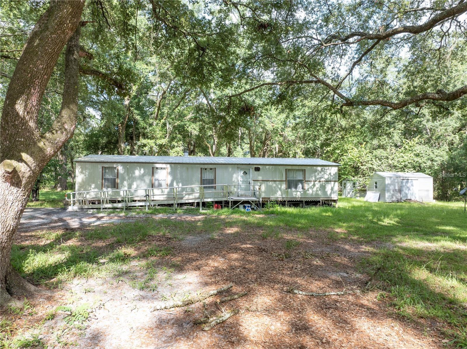 2.89 ACRES WITH MANUFACTURED HOME....Your new home with your new memories awaits!! This home is a 2-bedroom, 2-bathroom manufactured home with a spacious lot that is included with the home itself. NO LOT FEE!! This is truly country living at it's finest with being
