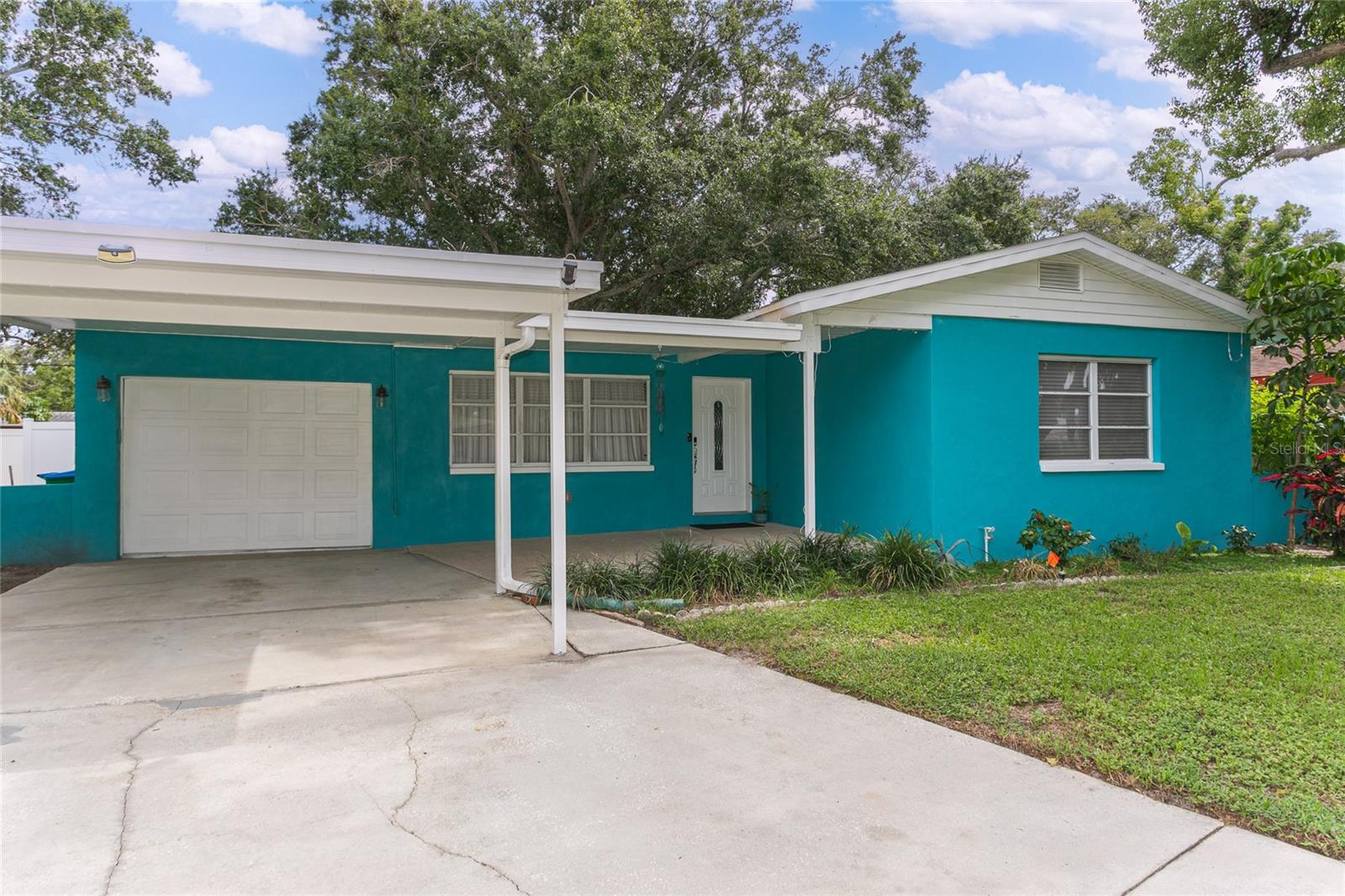 Updated 3BR/2BA home with garage & carport! Enjoy a remodeled kitchen, two updated baths, new flooring, and a brand-new HVAC (March 2025). Light-filled living spaces flow to a screened lanai and covered patio overlooking a spacious fenced yard with storage shed. Split plan with private primary suite. Convenient location near shopping, dining, Pinellas Trail & city park with playground, courts & fitness trail. Move-in ready and full of Florida charm!