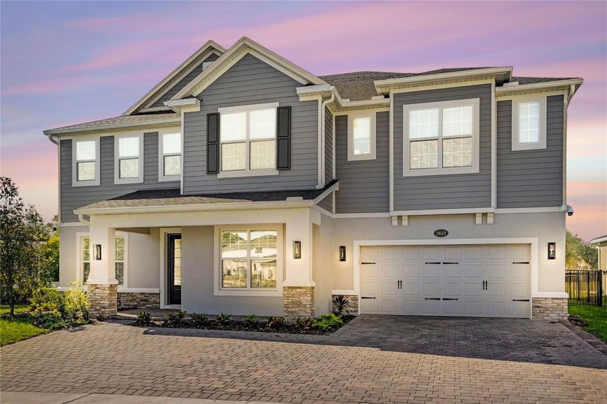 Welcome to Ravencliffe, a private gated enclave in the heart of Oviedo. Located off Alafaya Trail and Lake Hayes Road, this intimate 20-acre community offers a refined, boutique lifestyle with timeless Florida-inspired architecture, all close to Orlando’s premier dining, shopping, and entertainment.

Set on a spacious lot with picturesque pond views, this six-bedroom residence provides a peaceful setting and excellent outdoor living.

At the front of the home, a stylish lounge with a built-in dry bar and wine refrigerator creates an inviting first impression, complemented by a formal dining room nearby. The main level opens into a bright, open-concept living space where the kitchen and family room connect seamlessly. The chef’s kitchen serves as the focal point, featuring a waterfall quartz island with bar seating, matching quartz countertops and backsplash, double ovens, a pot filler, abundant cabinetry, a walk-in pantry, and designer lighting throughout. A butler’s pantry, coffee station, and built-in office nook add everyday convenience, while the dinette area overlooks the backyard and opens to a screened patio through sliding glass doors. A private guest suite with its own en-suite bath completes the first floor.

Upstairs, a spacious loft offers an ideal setting for entertaining, complete with a wet bar and wine refrigerator. All bedrooms are located on the second level, including the primary suite with a custom walk-in closet and a spa-inspired bath featuring a soaking tub and large walk-in shower. The sixth bedroom is currently used as a fitness studio with floor-to-ceiling mirrors and natural light. An upstairs laundry room with additional storage and a utility sink adds convenience.

The three-car garage provides ample space for vehicles and storage, along with a spacious driveway for additional parking. Approximately $200,000 in post-construction upgrades by the current owners further enhance the home’s quality and design.

This is a great opportunity to experience elevated living in one of Oviedo’s most desirable communities.