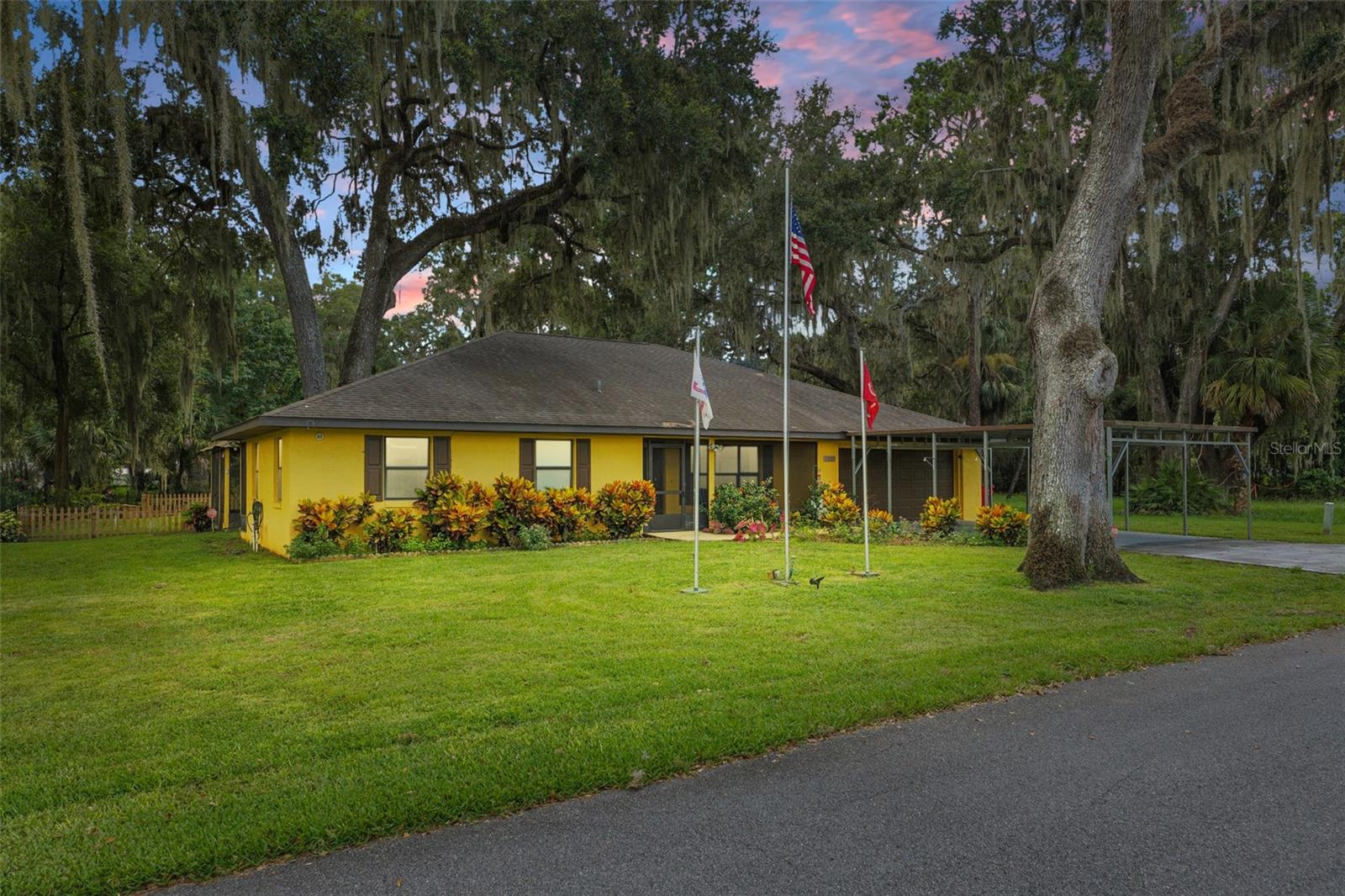 Make sure to check out the Virtual Tour for a 3D Model w/ Walkthrough, Floor Plan w/ Measurements, Video, & more! Relaxed Florida Living Vibes... you got them all day and night at this peaceful canal front home just 500 feet from the open spring fed Lake Panasoffkee! This 2bedroom PLUS bonus room, 2bath home, with huge screened in back patio, built in 2000 (with a 2019 roof & 2023 AC!) spans 1,532sqft of living space, with 2,488sqft total under roof on a .24-acre lot. Before you even step through the front door, you’ll be greeted by a screened-in porch, ideal for enjoying your morning coffee (bug-free!) to start your day off right! Bright and breezy indoors thanks to an open floor plan with vaulted ceilings and plenty of double-pane tilt-in windows (makes cleaning easier than you’d expect), the living area comes pre-wired for surround sound... so go ahead and crank up the movie nights or weekend playlists! The kitchen offers an abundance of cabinets, generous counter space, a breakfast bar, and even a dedicated coffee station - plus, it flows effortlessly into the dining area for easy entertaining and everyday convenience! The spacious primary suite has an ensuite bathroom with a garden tub and separate shower for a touch of everyday luxury. It also offers its own French door access to the massive screened-in cedar porch which practically doubles your living space and comes ready with speakers, a ceiling fan breeze, and views worth staying up late for. The second bedroom is on the opposite side of the home from the primary suite giving that true split floor plan, providing added privacy for guests or family. It’s a comfortable and functional space that feels just removed enough without being out of the way. Need extra space? No problem! This canal-front gem includes a bonus room that’s ready for whatever you need - office, guest space, or hobby hideaway! Another bonus incoming... NO carpet here! Just clean, low-maintenance flooring throughout (Living Room, Dining Area & Primary Bedroom new flooring 2024), plus an inside laundry room, alarm system, generator hookup, and a large extended two-car garage complete with a work table and built-in cabinets, perfect for weekend projects and extra storage. The backyard is perfect for pets, people, or planting your Florida favorites, featuring a beautifully landscaped yard with several well manicured flowering trees, wood-fenced space that offers a serene view of the canal (and quick access down the stairs in your back yard), making it your retreat to relax, entertain, or simply enjoy the surroundings! Just minutes from your doorstep, enjoy easy access to Lake Panasoffkee Fishing Pier, Panasoffkee Airboat Tours, and the family-friendly Cooter’s Pond Park. Outdoor lovers will appreciate nearby Withlacoochee State Forest for hiking and wildlife viewing. Whether you're downsizing, rightsizing, or you just want more serenity in your life... this home balances comfort, charm, and access to everything central Florida has to offer. Canal views / access... cedar porch vibes... Yes, please! Schedule your private showing today before someone else snags your seat on porch!