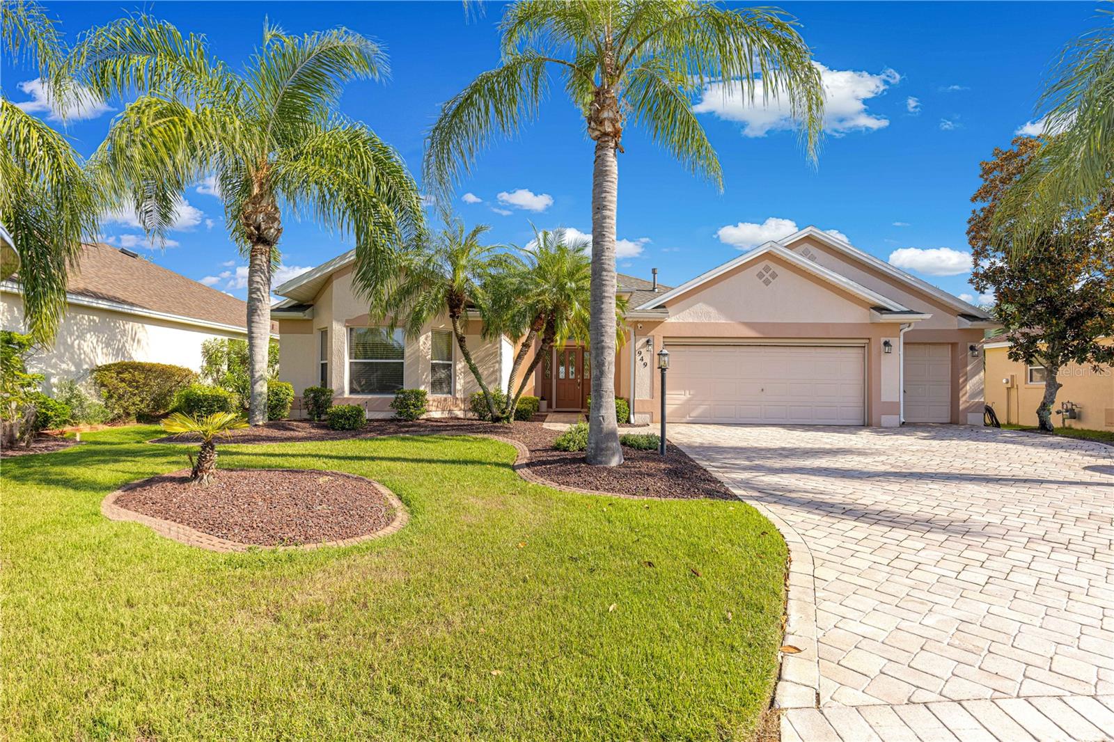 No Bond. This house is located just off of Canal street which gives you a direct short drive to Sumter Landing by golf cart or by car. This gorgeous Lantana was barely lived in and ready for it's new owner. The Bacall Golf Course that is behind this home has just been redone and the first tee box is straight out from your lanai. As you drive up to this beautiful home you will notice the extended garage with extended golf cart garage, upgraded landscaping that is all stone, the gorgeous paver driveway, and the added power screens on the garage doors. As you walk to the front door again you will notice the manicured landscaping and as you enter the front door you will be able to feel the openness of the home and all the great space you have to entertain a great group of friends or family. The very large and open concept allows you to be part of the conversation no matter what area of the great room that you are in. The kitchen is a cooks dream with the brand new quartz counters and the brand new kitchen appliances and the Gas Stove would make any cook want to stay in the kitchen to make that very special dish. The laundry room directly off the kitchen has plenty of space to fold and iron with a built in ironing board and also plenty of storage. The split floor plan allows your guests to have privacy and quietness from the rest of the home. The two full spare bedrooms and full bathroom with upgraded Quartz gives your guests the luxury of feeling like being on vacation with great friends. As you enter the master bedroom you will notice the large space for all of your furniture in addition to the walk in closet. The master bathroom has the quartz upgrade a beautiful walk in shower and a great bathtub for soaking and forgetting about your troubles. The Lanai has been extended freshly painted, an outdoor Kitchen added, and a lovely swim spa for watching the best sun set in The Villages. The roof was replaced 8/2025 The A/C was replaced 2019 and the Hot water heater was replaced 2018. Don't wait houses like this go fast. Call today for a private showing