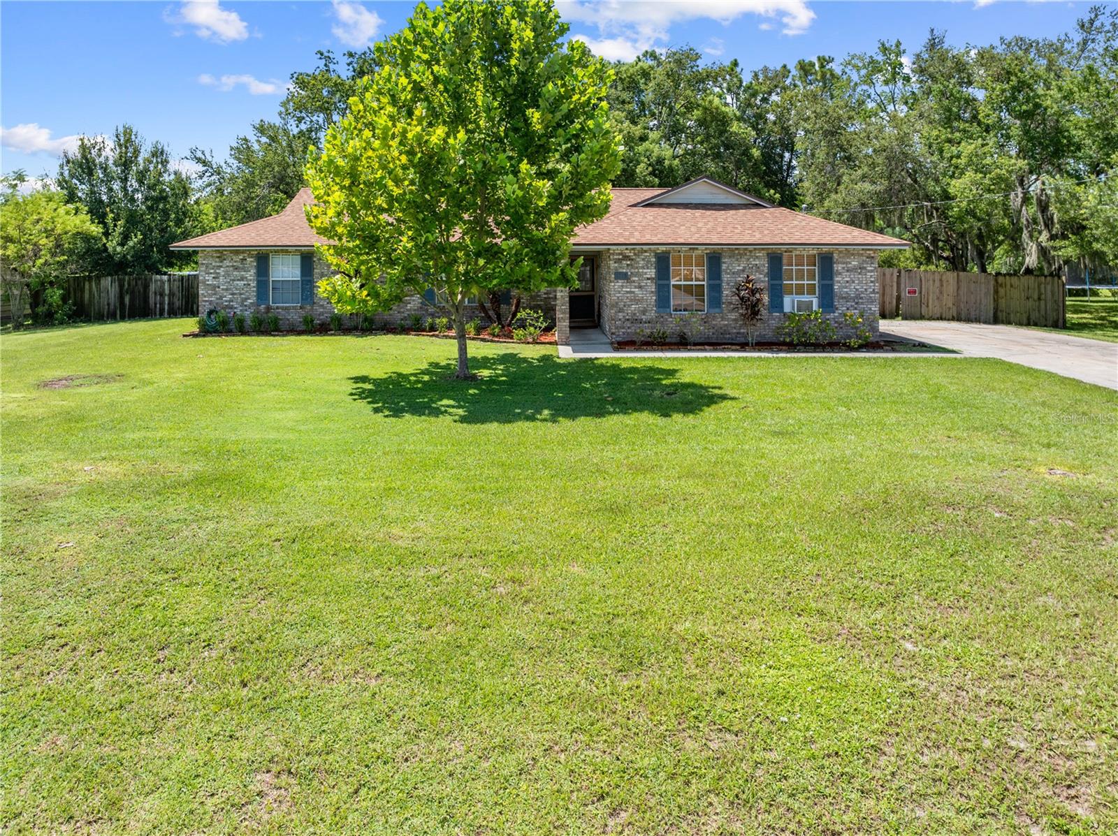 Located in the highly sought after Hickory Hollow community this 3 bedroom 2 bathroom home sits on nearly half an acre and offers the perfect blend of space, serenity and potential. NO HOA and NO zero lot lines! NEW ROOF IN 2021, NEW DRAIN FIELD IN 2018, NEW KITCHEN APPLIANCES IN 2022! Backing up to a tranquil pond you'll enjoy peaceful water views right from your backyard. Inside the home features a traditional layout and solid bones offering a fantastic opportunity for those looking to update and customize a property to their own tastes. Whether you're an investor or a buyer seeking a home you can make your own this one has endless potential. The 2 car attached garage has a conversion giving it an air conditioned flex space, great for a home gym, home office, workshop etc. In the large fenced in backyard you will find a covered 18X28 carport, great for storing outdoor toys, a boat, additional cars or turn it into a work space for your hobbies. There is also a great space for a few outdoor pets! Relax on the screened in back patio and start your day listening to the birds sing. Enjoy the quiet charm of country living with the convenience of being near the amenities that St. Cloud has such as restaurants, shopping, medical services etc. Don't miss your chance to own in one of the area's most desirable neighborhoods! Buyer and/or buyers agent to verify any/all information for accuracy including but not limited to taxes, HOA, zoning, restrictions, square footage, room sizes etc