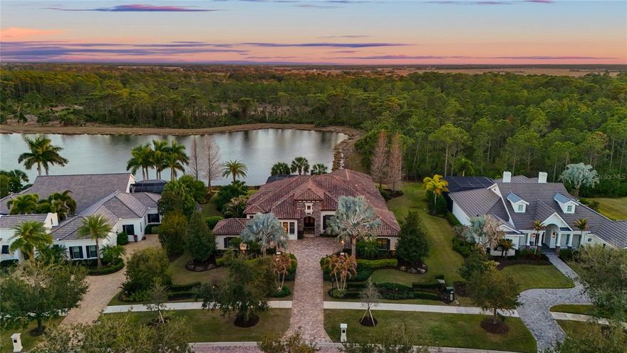 As you look out across the water from 19438 Beacon Park Place, there's nothing. No rooftops, no neighbors, no future build. Just preserve, sky, and the kind of protected view that defines true privacy within The Concession.
Set on more than half an acre of lakefront, this Arthur Rutenberg estate is the rare combination of build quality, setting, and finish level that simply isn't being recreated in today's market. Built in 2015 with masonry construction and a concrete tile roof, the home offers 4,110 square feet of considered living space and nearly 6,000 square feet under roof. The homesite backs directly to a protected preserve, ensuring the lake view and the natural backdrop remain undisturbed.
The chef's kitchen is the heart of the home. Wolf appliances, a Sub-Zero refrigerator, steam convection oven, warming drawer, pot filler, two dishwashers, dual islands, filtered water, a hidden pantry, and custom cabinetry with dimmable lighting throughout. It opens to a dining room framed by dramatic 90-degree sliding glass doors that fade away, pulling the outside in. The great room follows the same idea. Fully pocketing sliding glass doors blur the line between living space and outdoor living. Control4 smart home technology and integrated surround sound support 4K and 8K entertainment without cluttering the design.
The club room was built for hosting. Dual bar areas, wine refrigeration, a beverage center, ice maker, dishwasher, and layered lighting zones. A second set of 90-degree sliders opens it directly to the lanai, so the space breathes when guests arrive.
Outside, a resort-style pool and spa, screened enclosure, outdoor kitchen, and cabana with gas fireplace overlook sweeping lake and preserve views. Remote-controlled fans, custom lighting, and that uninterrupted backdrop give the space a quiet, private resort feel.
The primary suite opens directly to the pool and includes dual custom closets, a spacious walk-in shower, and private security panel access. A second guest suite with full bath and an additional front guest room with full shower offer flexibility for extended stays or multi-generational living. An oversized office with courtyard access makes working from home feel like a retreat rather than an obligation.
Behind the finishes, the infrastructure matches the design. A Kohler whole-house generator, tankless water heater with instant hot water, whole-house water filtration, high-pressure water pump, central vacuum, plantation shutters throughout, new mini-split AC in the garage, a three-car garage with extended bump-outs, and a full security system covering doors and windows.
The Concession itself is one of the most quietly prestigious communities in the area, anchored by a Jack Nicklaus Signature golf course and known for the privacy and discretion of its residents. This is the rare opportunity to acquire a home of this caliber, on a homesite of this protection, in a community of this prestige, ready to live in today.