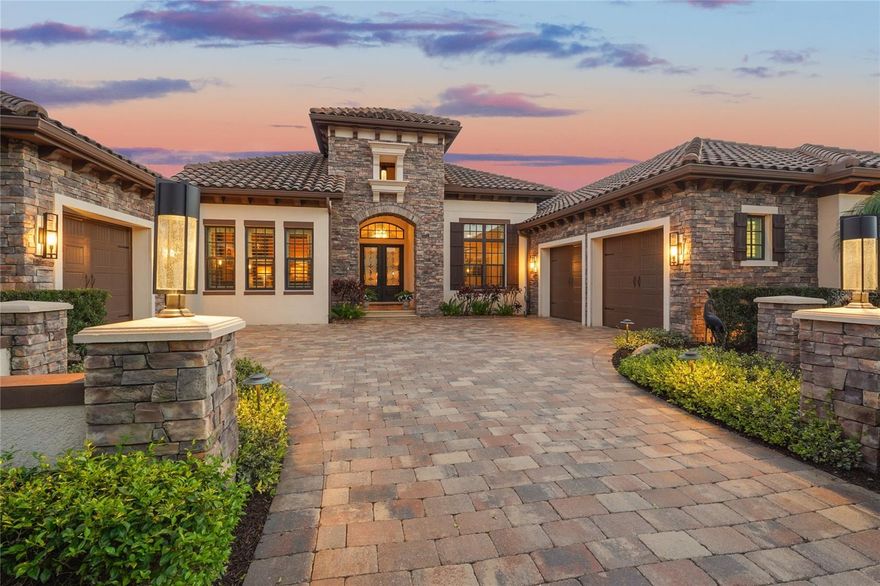 Welcome to 19438 Beacon Park Place in The Concession, a privately positioned lakefront residence set on over half an acre with preserve views and no rear neighbors. Built in 2015 with masonry construction and a concrete tile roof, this 4,110-square-foot home offers nearly 6,000 square feet under roof and blends architectural detail, modern infrastructure, and thoughtful design for both everyday living and entertaining.
The chef’s kitchen serves as the centerpiece of the home, featuring Wolf appliances, a Sub-Zero refrigerator, steam convection oven, warming drawer, pot filler, two dishwashers, dual islands, filtered water, hidden pantry, and custom cabinetry with dimmable lighting throughout. The kitchen flows into the dining room, where dramatic 90-degree sliding glass doors frame the space and open directly to the lanai.
The great room features fully pocketing sliding glass doors that create a seamless connection between the interior living area and outdoor living space. Integrated Control4 smart home technology and surround sound support modern 4K and 8K entertainment systems while maintaining a clean, sophisticated design.
Designed with hosting in mind, the club room includes dual bar areas, wine refrigeration, beverage center, ice maker, dishwasher, and multiple lighting zones. A second set of 90-degree sliding glass doors opens this space to the lanai, creating exceptional indoor-outdoor flow.
The outdoor living area is designed for both relaxation and entertaining, complete with a resort-style pool and spa, screened enclosure, outdoor kitchen, cabana with gas fireplace, remote-controlled fans, custom lighting, and sweeping lake and preserve views that provide exceptional privacy within the community.
The primary suite offers direct pool access, dual custom closets, a spacious walk-in shower, and private security panel access. A second guest suite with full bath and an additional front guest room with full shower provide flexibility for extended stays or multi-generational living. An oversized office with courtyard access offers a comfortable and versatile work-from-home space.
Additional highlights include a Kohler whole-house generator, tankless water heater with instant hot water, whole-house water filtration system, high-pressure water pump, central vacuum, plantation shutters throughout, new mini-split air conditioning in the garage, a three-car garage with extended bump-outs for storage or hobbies, and a full security system covering doors and windows.
Located within one of the area’s most respected golf and luxury communities, this residence offers a rare combination of craftsmanship, privacy, and thoughtfully integrated systems. Homes built to this level of detail, on a homesite of this size and setting, are increasingly difficult to recreate in today’s construction environment, making this a distinctive opportunity within The Concession.