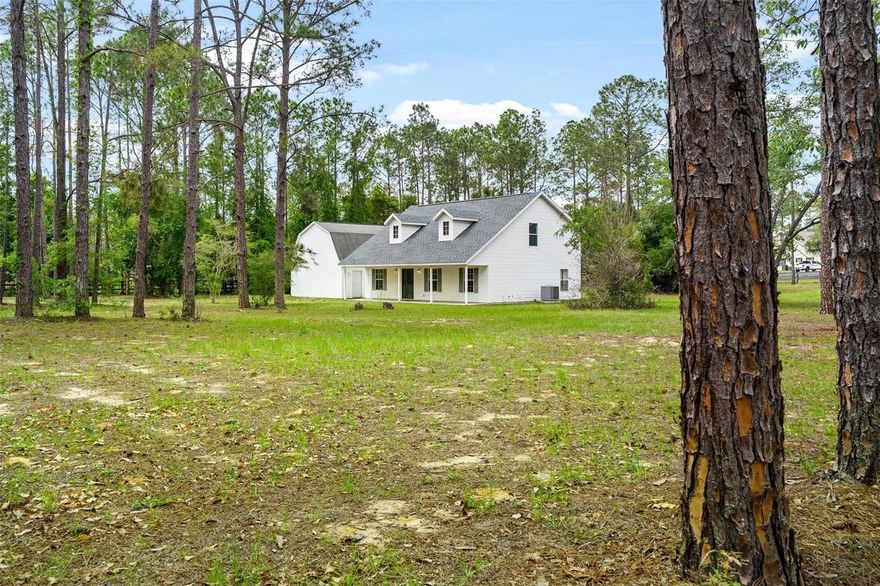 This comfortable, no-nonsense home is a GREAT OPPORTUNITY to enjoy COUNTRY LIVING without breaking the budget. Set on nearly 5 ACRES, there’s room for HORSES, dogs, gardening, or simply enjoying the space. Inside offers a practical 4-bedroom, 2-bath layout with SIMPLE LINES, and flexibility for bedrooms, office, or hobbies. The home has great bones and is READY for YOUR PERSONAL TOUCH, tucked behind the trees for PRIVACY, and still with CONVENIENT ACCESS for Orlando commuting. The 24x30 DETACHED GARAGE fits at least 3 VEHICLES, plus space for equipment or a WORKSHOP. Seller notes MAJOR UPDATES including ROOF (2021), Water Heater (2024), and Septic serviced (2026). A 1-year AHS HOME WARRANTY is included for YOUR PEACE OF MIND. Located just outside of Mount Dora with easy access to Orlando, this is an affordable way to enjoy country life. CALL YOUR REALTOR and take the first step to YOUR FUTURE.