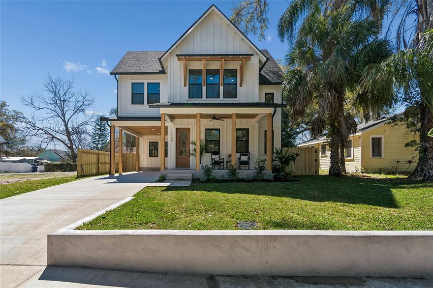 WELCOME TO 1709 E HENRY AVENUE!  This simply stunning new construction home is ready to be called HOME. Nestled on a picturesque, tree-lined street in sought-after Seminole Heights, this Modern Craftsman residence offers over 2,500 square feet of beautifully designed living space, featuring 4 bedrooms, 4 bathrooms (three with en-suite baths), a dedicated laundry room, single-car carport, and a fully fenced backyard. From the moment you arrive, the welcoming front porch sets the tone — the perfect place to unwind and enjoy the charm of the neighborhood. Step inside and you’re greeted by soaring 10-foot ceilings adorned with crown molding, Level 4 textured walls, and stunning wide-plank wood flooring that flows throughout the home (excluding bathrooms and laundry).  The kitchen is truly the centerpiece — designed to impress and built for everyday living. It features an oversized island with eat-at bar and additional storage, quartz countertops, a striking hood vent with custom wood trim to complement the island, abundant cabinetry with under-cabinet lighting, and a walk-in pantry. The Samsung Bespoke white glass appliance package elevates the space even further, including a smooth-top induction range with convection oven and a three-door French-style refrigerator with a convenient water station. The first floor also offers a versatile guest bedroom that could be great for home office or playroom — along with a full guest bath featuring a tub/shower combination and a linen closet.  Upstairs, you’ll find two generously sized secondary bedrooms, each with its own en-suite bath. One features a large walk-in shower with glass enclosure and dual shower heads, while the other offers a tub/shower combination. The thoughtfully designed laundry room includes cabinetry, a laundry sink, and quartz countertops for added convenience and style. Saving the best for last — the primary suite is a true retreat. Spacious and serene, it features a large walk-in closet and a luxurious en-suite bath complete with an oversized glass-enclosed shower with dual shower heads, separate vanities with lighted mirrors, quartz countertops, and a private water closet. Step outside to the fully fenced backyard where you can enjoy outdoor games, weekend BBQs, or relaxing evenings on the back porch! Additional features include Ceiling fans on both porches, Full-yard irrigation system with French drains, St. Augustine sod selected for shaded areas, landscaping package with flowering plants.  Enjoy walkability to Lake Roberta and nearby Publix, while being centrally located to some of Tampa’s finest attractions and dining destinations including Armature Works, Sparkman Wharf, Florida Aquarium, Channelside District, and Zoo Tampa at Lowry Park. This home perfectly blends modern design, thoughtful craftsmanship, and an unbeatable location — a rare opportunity in the heart of Tampa.