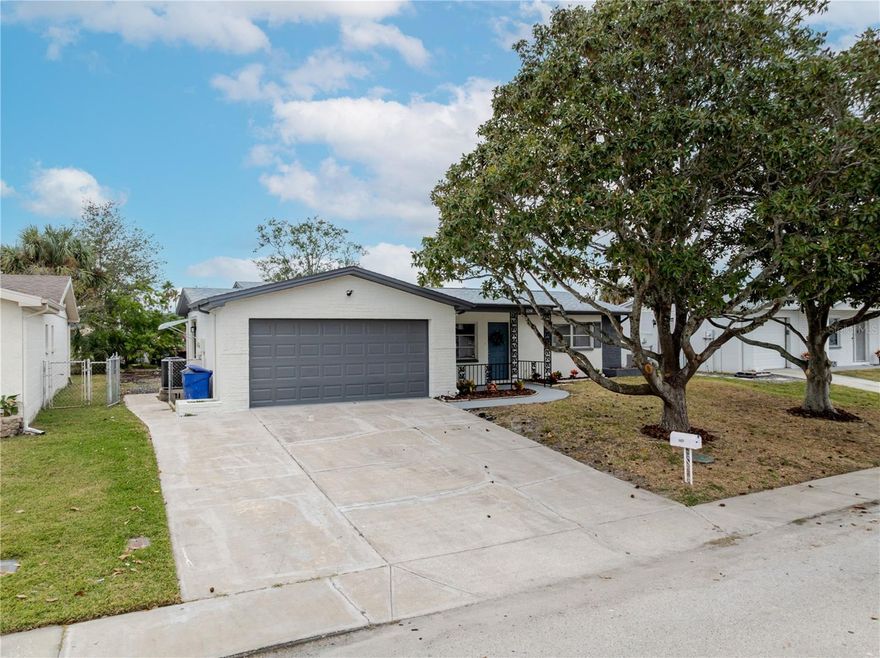Welcome to this beautifully refreshed 3-bedroom, 2-bath, 1,214 sq ft pool home in the highly sought-after Port Richey area — no flood zone, featuring a 2025 roof and 2017 AC system. Step inside to discover a bright and inviting layout designed for everyday comfort and entertaining. The interior features a fresh coat of paint inside and out and new luxury vinyl plank flooring throughout, creating a clean and cohesive look across every room. The kitchen showcases contemporary white shaker cabinetry, fresh white quartz countertops, a full suite of brand new stainless steel appliances, and a peninsula with a cozy breakfast bar. Both bathrooms feature modern tile designs, stylish vanities with quartz tops, and sleek plumbing and lighting fixtures. Out back, a large screened-in pool and spacious patio area create the perfect setting for relaxing or entertaining. The two-car garage offers generous storage and convenient washer and dryer hookups. Ideally located just minutes from shopping, dining, and entertainment, with easy access to US-19 and the Suncoast Parkway for a quick commute to Tampa or the beaches. This home blends modern style with everyday functionality—ready for its next owner to enjoy.