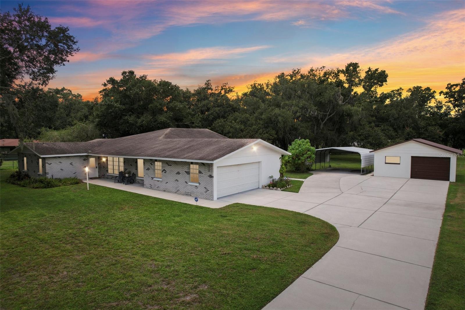 Welcome Your Multi-Generational Oasis in Plant City complete with extra garages & storage on 2+ acres of beautiful high & dry fenced property that welcomes all animals. This beautifully maintained ranch-style home offers the perfect blend of space, privacy, and versatility for multi-generational living featuring an addition in 2016 that added an additional living room, large 2nd master bedroom with handicap accessible bathroom and walk in closet. The original master bedroom also has a private ensuite bathroom with handicap accessible step or roll in shower that was recently professional updated with double closets for extra storage. The main home features an open-concept layout with sunlit living and dining areas, a large kitchen with beautiful granite counters and breakfast bar with a family room that opens to a patio overlooking the expansive fenced backyard. As you arrive, a long private driveway leads you through lush landscaping and mature trees to a welcoming front porch and a spacious detached garage/workshop—perfect for extra vehicles, hobbies, or storage. Extra bonus features include a whole home Generac system with auto switch connections, New roof in 2016, new septic in 2016, 2 AC systems installed in 2016, updated water supply lines & icynene insulation for low energy bills. This property is located on well & septic for no water bills and there is no HOA or deed restrictions. Zoned AS-1 to allow additional homes to be built and in-law homes and also allows all of farm animals.This home is thoughtfully designed to accommodate aging parents, adult children, or extended family with ease. The generous outdoor space offers endless possibilities—from gardening and play areas to future guest quarters or recreational additions. Located just minutes from schools, parks, shopping, and dining, this property combines rural tranquility with urban convenience. Whether you're hosting family gatherings or enjoying quiet evenings under the stars, 1219 Lindsey Road is more than a home—it's a lifestyle ideal for families seeking room to grow, gather, and thrive together. Schedule your private tour today and discover the possibilities of multi-generational living in Plant City!