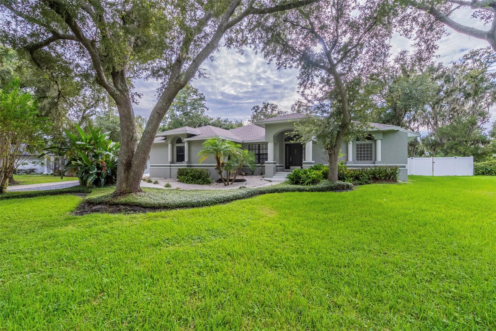 This beautifully updated 3-bedroom, 2-bath single-story home features a new roof, fresh interior paint, new carpet, stylish light fixtures, and refreshed bathrooms. The kitchen shines with new quartz countertops, while the living room offers vaulted ceilings, a stone fireplace, and built-in shelving. Enjoy abundant natural light from tons of windows and a Florida room with French doors, all set on a spacious yard perfect for outdoor living.