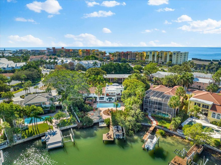 HUGE PRICE ADJUSTMENT from motivated sellers. The possibilities are endless with the special property. Discover a symphony of serenity and excitement with this truly magical property. Whether you crave privacy as a family compound or are looking for a true entertainers delight this residence has something for everyone. The home is perfectly positioned to maximize the usage of the OVERSIZED LOT. This waterfront home is more than a house; it's a canvas for your dreams. Seize the opportunity today to bring your vision to this waterfront residence.
The Mediterranean style is reminiscent of something from southern California and offers many flexible living options. Upon arrival you will notice the lush tropical landscape that provides privacy and seclusion from the street. The kitchen and bar area are wonderful for both everyday use and for hosting large gatherings. Family living space surrounding the heart of the home. The first level has two bedrooms one of which is currently being used as a study. Take the ELEVATOR or the stairs to the second floor.

The second floor has a large media room complete with drop down cinema style screen and sound system that will convey with the home. Each bedroom has their own spectacular ensuite bath. The owner's suite overlooks the water and a large terrace perfect for morning coffee or evening cocktails.

Imagine owning a property so special that you evoke a feeling of living in your own private resort. Enjoy sitting on your private dock with views of Boca Ciega Bay or drop the boat lift and hop on your boat to enjoy time on the water with convenient Gulf access through John's Pass. Just across Gulf Boulevard soak up the sun and unparalleled sunsets on the white sandy beaches or visit one of the many local eateries, taverns and shops. Call today for your private tour of this MUST SEE rare and spacious home.