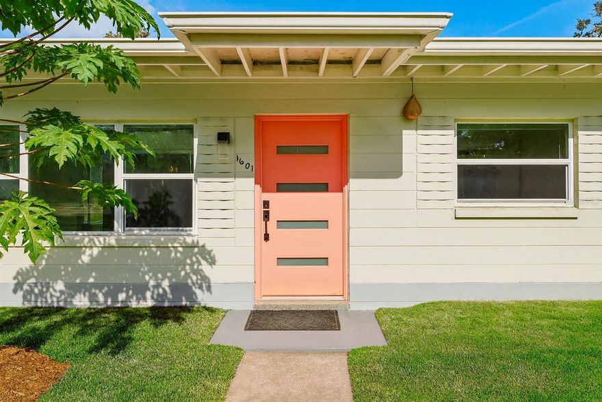 Welcome to 1601 Triangle Avenue, a beautifully updated block home in the heart of Orlando’s vibrant SoDo district, known for its tree-lined streets, locally loved eateries and breweries, scenic parks, top-rated schools, and the unbeatable convenience of being minutes from Downtown Orlando, Orlando Health, and major roadways. This spacious 3 bedroom, 2 bathroom home offers 1,684 square feet of light-filled living space with an easy, flowing layout and multiple oversized gathering areas that allow you to relax, entertain, and truly spread out. The updated kitchen features quartz countertops, stainless steel appliances, and wood cabinetry and is thoughtfully positioned between the dining and family rooms for effortless daily living. Terrazzo and tile floors run throughout, with no carpet anywhere, and the home is enhanced by modern chic fixtures and brand new fans that elevate every room. Both bathrooms are completely renovated with a fresh, timeless feel. The fully fenced backyard is ideal for furry friends and includes a gazebo perfect for relaxing evenings, weekend cookouts, or peaceful mornings surrounded by mature papaya and avocado trees. A dedicated laundry room with washer and dryer, a separate storage room, and a driveway that easily fits three or more cars add wonderful everyday ease. With a newer roof, AC, and water heater, you can move in with peace of mind. Located just minutes from Delaney Park, Boone High School, Wadeview Park, public transportation along Michigan Avenue, and everything the SoDo lifestyle is loved for, this home blends comfort, convenience, and neighborhood charm, making it truly a rare find. Experience the best of Orlando living at 1601 Triangle Avenue.