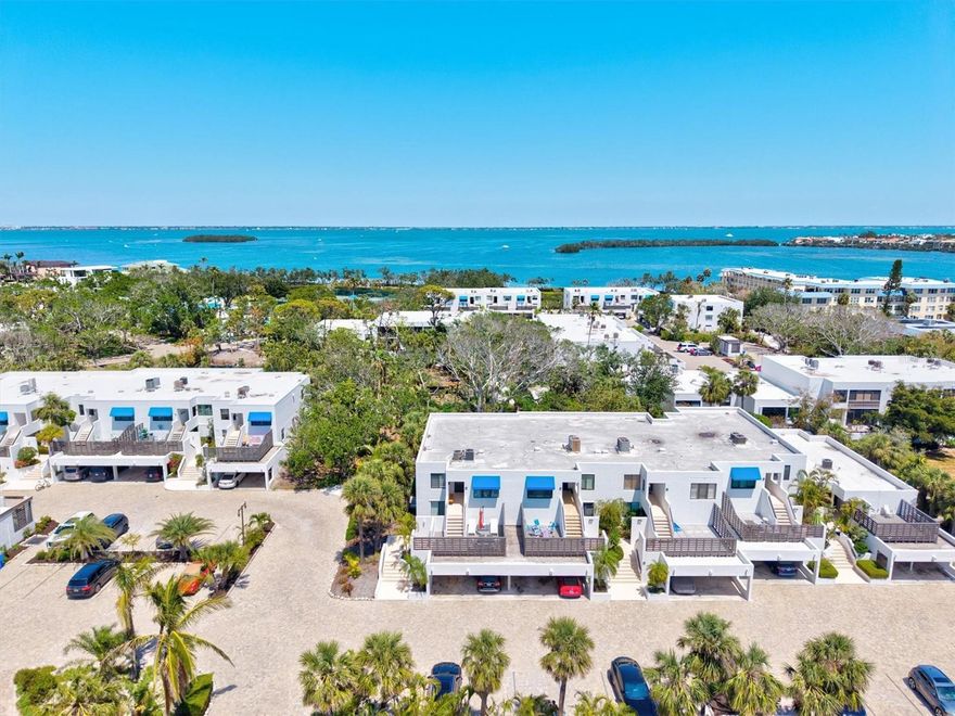 Experience contemporary coastal living in this fully renovated, turnkey-furnished unit ideally located in the heart of Longboat Key! Nestled between 1,200 feet of private, powder-soft beach on the Gulf and a serene fishing pier on Sarasota Bay, this residence offers the perfect blend of island tranquility and luxury!Step inside to discover a meticulously cared for interior space updated with elegant flooring, a sleek kitchen, spa-inspired bathrooms, high-end appliances, tankless water heater, designer lighting, and custom furnishings throughout featuing a neutral yet distinctive décor, creating a relaxed coastal ambiance. Added conveniences include a full-size stacked washer and dryer in a discreet laundry closet, and a private under-building carport with a secure storage closet.Located within the architecturally significant Bayport Beach & Tennis Club, the community spans across 27 lush Gulf-to-Bay acres. Residents enjoy a wealth of resort-style amenities including: A private Gulf-front beach with chaise lounges and umbrellas, on site nature trails, lakes with fountains, a bayside fishing pier with kayak launch, heated Junior Olympic-sized pool, Har-Tru tennis courts, bocce ball, and a fitness center!