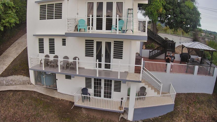 Mango Hill Retreat — Your Dream Rincón Investment Awaits
Perched on a lush hillside in the heart of Rincón, Puerto Rico's most celebrated surf town, Mango Hill Retreat is a stunning 3-story, 3-bedroom/2.5 -bathroom home offering panoramic 360-degree views and an already thriving Airbnb business — listed at $749,000.
From the moment you step through the gated entrance, flanked by towering mango trees that give this retreat its name, you know you've found something special. The property is set on a generous, beautifully maintained lot with mature tropical trees, open lawn areas, and multiple private decks on every level — perfect for morning coffee with ocean breezes or evening sunset gatherings. A covered outdoor lounge with a grill gazebo completes the ultimate Caribbean entertaining setup.
Inside, the home is thoughtfully finished with tile floors, mini-split A/C in every room, and light-filled interiors. Each floor opens to its own balcony or terrace, creating an effortless indoor-outdoor flow that guests rave about.
Location is everything here. You're less than 5 minutes from world-famous Domes Beach and Sandy Beach, Rincón's premier surf breaks that draw riders from around the globe. Steps Beach — beloved by snorkelers for its crystal-clear waters and marine reserve — is a short drive away, as is Playa Doña Lala, a favorite local hangout with vendors, volleyball, and jaw-dropping sunsets. The Rincón Surf School & Resort is practically in your backyard for lessons and rentals, and Rincón's charming town square with its restaurants, bars, and shops is just minutes away.
With a security camera system already installed, an established Airbnb brand, and consistent rental income potential in one of Puerto Rico's hottest tourism destinations, this property is as turnkey as it gets. Whether you're looking for a personal retreat, a vacation home, or a high-performing short-term rental, Mango Hill is the one.