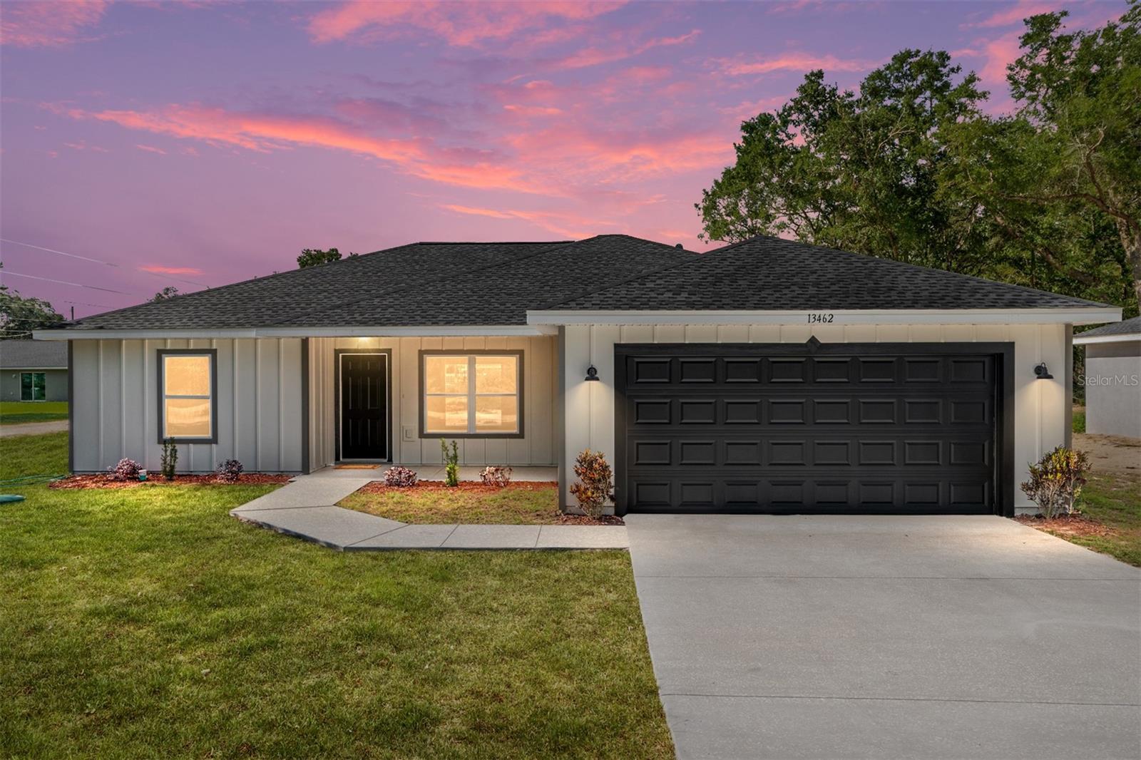 Country living at its finest! New home on an undeveloped road. Introducing the Orchid III by Bakan Homes. This brand-new 3-bedroom, 2-bathroom home offers 1,576 sq ft of thoughtfully designed living space, blending rustic charm with modern finishes. Situated between SW 159th Ct and SW 20th Place, this beauty features durable cement siding along the exterior of the home. The welcoming front porch boasts a tongue-and-groove ceiling that adds a warm, rustic touch to the home’s curb appeal. Step inside to discover luxury vinyl waterproof flooring throughout and stylish black finishes that bring a bold, modern contrast. The heart of the home is the stunning kitchen, showcasing a 9-foot island, quartz countertops, solid wood soft-close cabinetry, stainless steel appliances (including dishwasher), and modern pendant lighting—perfect for entertaining and everyday living. The primary suite is a true retreat with an expansive 18x15 layout, private access to the rear patio, and a spa-like bathroom complete with dual vanities, a rainfall shower, and recessed lighting. Secondary bedrooms are generously sized at 13x11, offering comfort and flexibility for family or guests. Your investment is protected by a limited Builder Warranty that expires 1 year after the issuance of the Certificate of Occupancy. Pictures are of actual jobsite. Colors, finishes, and appliances may vary from home to home. Estimated completion dates are only an estimate and can be delayed due to unforeseen circumstances. Pictures are of a recently completed model and the subject home does not come with tile backsplash in the kitchen.