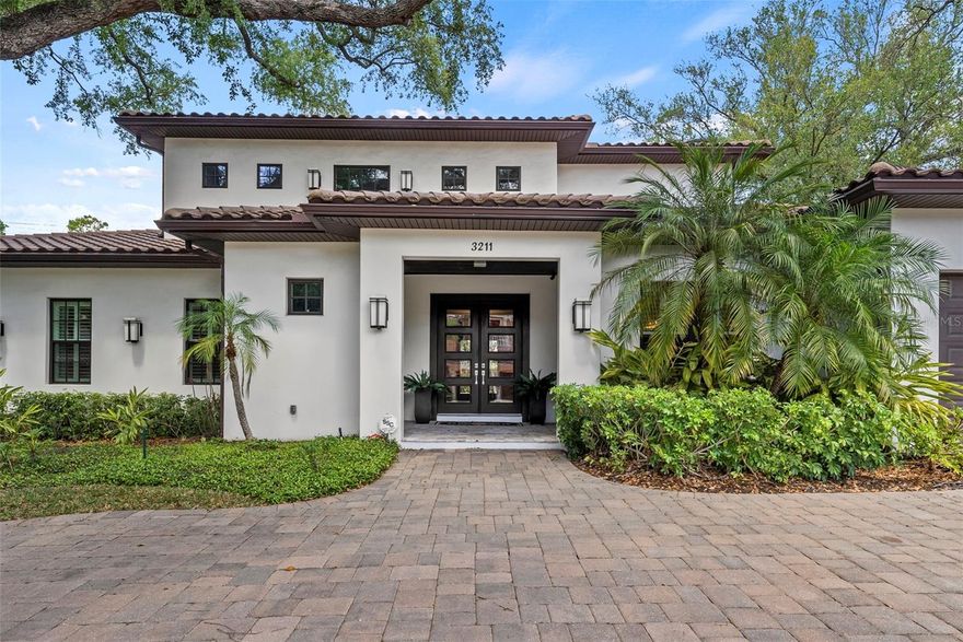 Welcome to this stunning 5-bedroom, 4.5-bathroom pool home in the highly sought-after Bayshore Beautiful neighborhood. Designed for both everyday living and effortless entertaining, this home is enhanced by soaring 10-foot ceilings, plantation shutters, and thoughtfully selected finishes throughout. The main level primary suite is privately situated on one side of the home, while an additional guest suite is positioned on the opposite side, offering ideal separation. Between them, the quiet living room—complete with a cozy gas fireplace—and the spacious kitchen create a natural buffer while still maintaining a seamless flow. Additional features on the main level include a dedicated office, half bathroom, and a well-appointed laundry room. Upstairs, you’ll find a generous loft-style living area along with one private en-suite—perfect for guests or multigenerational living—as well as two additional bedrooms and a hallway bathroom. Step outside to your private backyard oasis and enjoy true indoor-outdoor living. The enclosed lanai, equipped with phantom screens, allows you to open up the space to the outdoors while maintaining comfort and versatility year-round. Beyond, a saltwater pool, full-size outdoor kitchen, and fire pit create the ultimate setting for relaxing or entertaining. Completing the home is an oversized two-car garage offering ample storage and functionality, along with a semi-circle driveway that provides additional parking. This home perfectly blends comfort, style, and location—an exceptional opportunity in one of South Tampa’s most desirable neighborhoods.