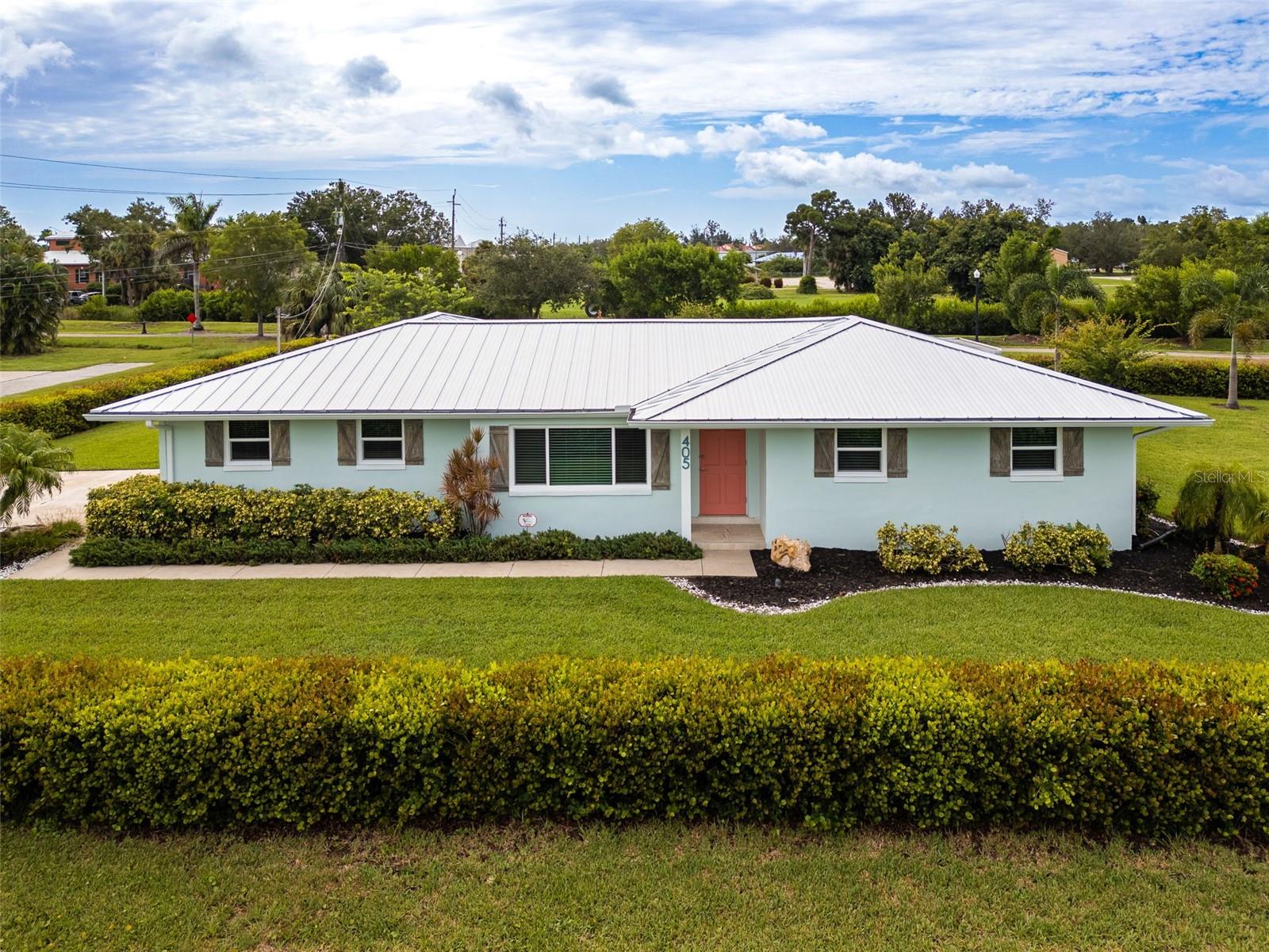 Welcome to this exceptional home located on a peaceful street in beautiful downtown Punta Gorda. Only 4 blocks from Gilchrist Park and Charlotte Harbor, you will have easy access to all that downtown Punta Gorda has to offer including many shops, restaurants, boutiques and weekend farmer’s market! This gorgeous half-acre lot is surrounded by cocoa plum bushes which provide a perfect oasis of privacy hidden in the middle of downtown Punta Gorda. Behind the home is the Linear Park Trail, which is a great walking/biking trail that leads to the Punta Gorda Library and Historic Park, The Visual Arts Center, and Fisherman’s Village. This concrete-block home has 3 bedrooms, 2 full bathrooms and an oversized 2 car garage. The tranquil den/3rd bedroom offers the perfect retreat for relaxation or a sophisticated home office. A charming custom-painted lanai is a perfect beach-themed place to enjoy an evening drink with friends. Granite countertops, custom wood cabinets, spacious island, and a breakfast bar with plenty of storage finish off a kitchen perfect for entertaining guests. Many upgrades make this home a showstopper! New metal roof in 2023, new hurricane rated garage door in 2024, whole house re-pipe in 2023, new A/C in 2023, new impact windows in 2024, new tile in 2025, and landscaping was done in 2023. The newly refreshed interior is beautifully decorated and can be sold turnkey! All you’d have to provide is your clothing! A rare blend of luxury, charm, and modern updates, this one-of-a-kind property is ready to welcome you home. Schedule your private tour today and experience it for yourself!