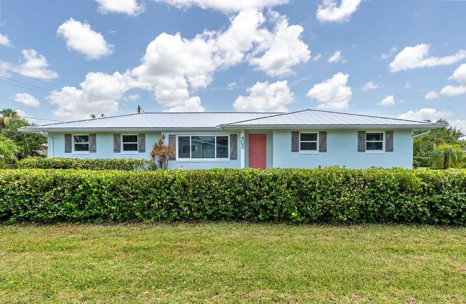Welcome to this exceptional home located on a peaceful street in beautiful downtown Punta Gorda. Only 4 blocks from Gilchrist Park and Charlotte Harbor, you will have easy access to all that downtown Punta Gorda has to offer including many shops, restaurants, boutiques and weekend farmer’s market! This gorgeous half-acre lot is surrounded by cocoa plum bushes which provide a perfect oasis of privacy hidden in the middle of downtown Punta Gorda. Behind the home is the Linear Park Trail, which is a great walking/biking trail that leads to the Punta Gorda Library and Historic Park, The Visual Arts Center, and Fisherman’s Village. This concrete-block home has 3 bedrooms, 2 full bathrooms and an oversized 2 car garage. The tranquil den/3rd bedroom offers the perfect retreat for relaxation or a sophisticated home office. A charming custom-painted lanai is a perfect beach-themed place to enjoy an evening drink with friends. Granite countertops, custom wood cabinets, spacious island, and a breakfast bar with plenty of storage finish off a kitchen perfect for entertaining guests. Many upgrades make this home a showstopper! New metal roof in 2023, new hurricane rated garage door in 2024, whole house re-pipe in 2023, new A/C in 2023, new impact windows in 2024, new tile in 2025, and landscaping was done in 2023. The newly refreshed interior is beautifully decorated and can be sold turnkey! All you’d have to provide is your clothing! A rare blend of luxury, charm, and modern updates, this one-of-a-kind property is ready to welcome you home. Schedule your private tour today and experience it for yourself!