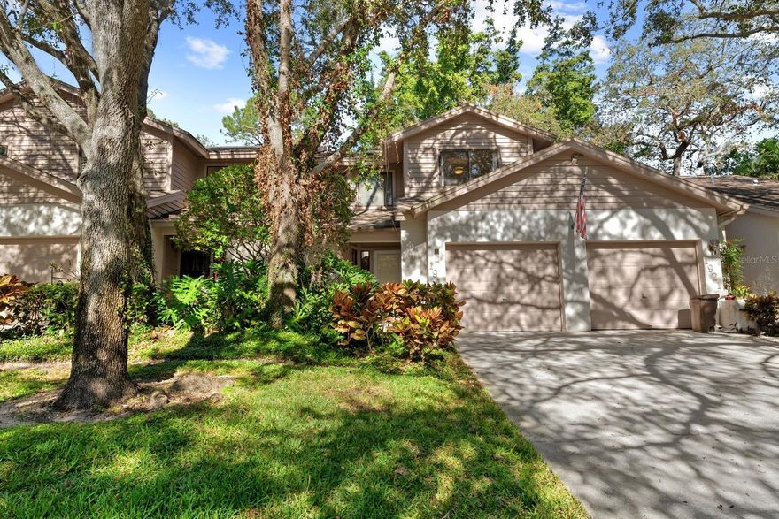 Completely Updated Townhome in Whispering Woods  Community with Stunning Features & Prime Location! Welcome a highly desirable community offering peace, security, and convenience just minutes from Tampa International and St. Pete/Clearwater airports, world-famous Sponge Docks, and the vibrant downtown Tarpon Springs scene filled with dining, music, art, and culture PLUS the very popular East Lake corridor for all the Golf and leisure one can handle! This immaculate 3-bedroom, 2.5-bath townhome is light, bright, and thoughtfully designed for everyday living and effortless entertaining. All BRAND NEW luxury flooring and FRESH interior paint. Enjoy consistent stunning stone countertops, custom cabinetry, and custom closet organizers in every room, including a charming third bedroom/home office complete with a custom built-in bookcase and walk-in closet. Upstairs, the massive master suite boasts soaring ceilings and a luxurious feel, while the convenient upstairs laundry keeps everything within reach. Step outside to your large concrete patio which is perfect for casual backyard barbecues, relaxing evenings, or entertaining guests in your bonus outdoor space. Love the outdoors? Right outside the gates is direct access to the PINELLAS TRAIL, where you can bike or walk to the Sponge Docks, charming downtown Tarpon Springs, and beyond — making it easy to enjoy all the area has to show without ever getting in the car. Community amenities include a sparkling SALTWATER pool, serene lakefront dock and pier, and breathtaking views where wildlife and nature abound. Ideal for relaxing in this peaceful, quiet enclave. The low HOA covers major expenses such as roof maintenance, exterior painting, and more — making this a smart and low-stress investment. To top it off, the seller is including a full one-year Ultimate Plan Choice Home Warranty for added peace of mind. Don’t miss this turn-key opportunity to own a beautifully updated home in one of the area's best-kept secrets! Schedule your showing TODAY!!