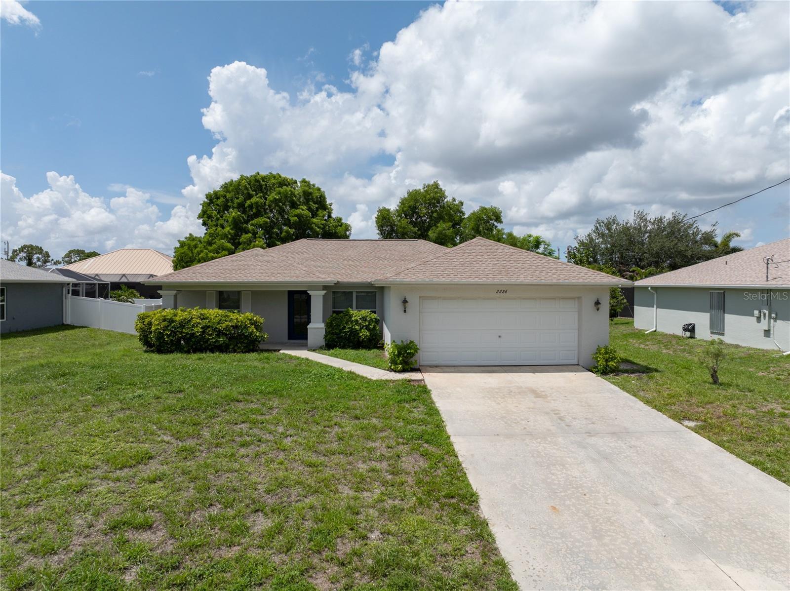 Welcome home to 2226 NE 34th Terrace – a beautiful and budget-friendly gem in the heart of Cape Coral! This charming 3-bedroom, 2-bathroom home is perfect for families looking for comfort, space, and convenience—all at an affordable price. With 1,408 square feet of living space and a split-bedroom layout, this home gives everyone in the family their own space while keeping the main living areas open and inviting. You'll love the stylish luxury vinyl flooring throughout, making clean-up a breeze for busy households. The kitchen is the heart of the home, featuring tons of cabinet space, a large pantry, and an open layout that flows into the dining and living areas—perfect for family meals and weekend gatherings. The master suite offers a quiet retreat with a walk-in closet and a full en-suite bathroom, while the two guest bedrooms are tucked away on the opposite side of the home with a shared hallway bath, ideal for guests. Enjoy morning coffee on the charming front porch with decorative columns or relax in the screened lanai out back—great spots for winding down after school or work. There's even a laundry room with extra storage and direct garage access, plus a new roof (2023) and new A/C (2018) for peace of mind. This home was built by First Home Builders (St. Michael Model) and is located just minutes from top-rated schools, shopping, parks, and everyday essentials. If you’ve been dreaming of owning a move-in-ready home in a great neighborhood without stretching your budget—this is it! Don’t wait—this family-friendly Cape Coral home is priced to sell and won’t last long!