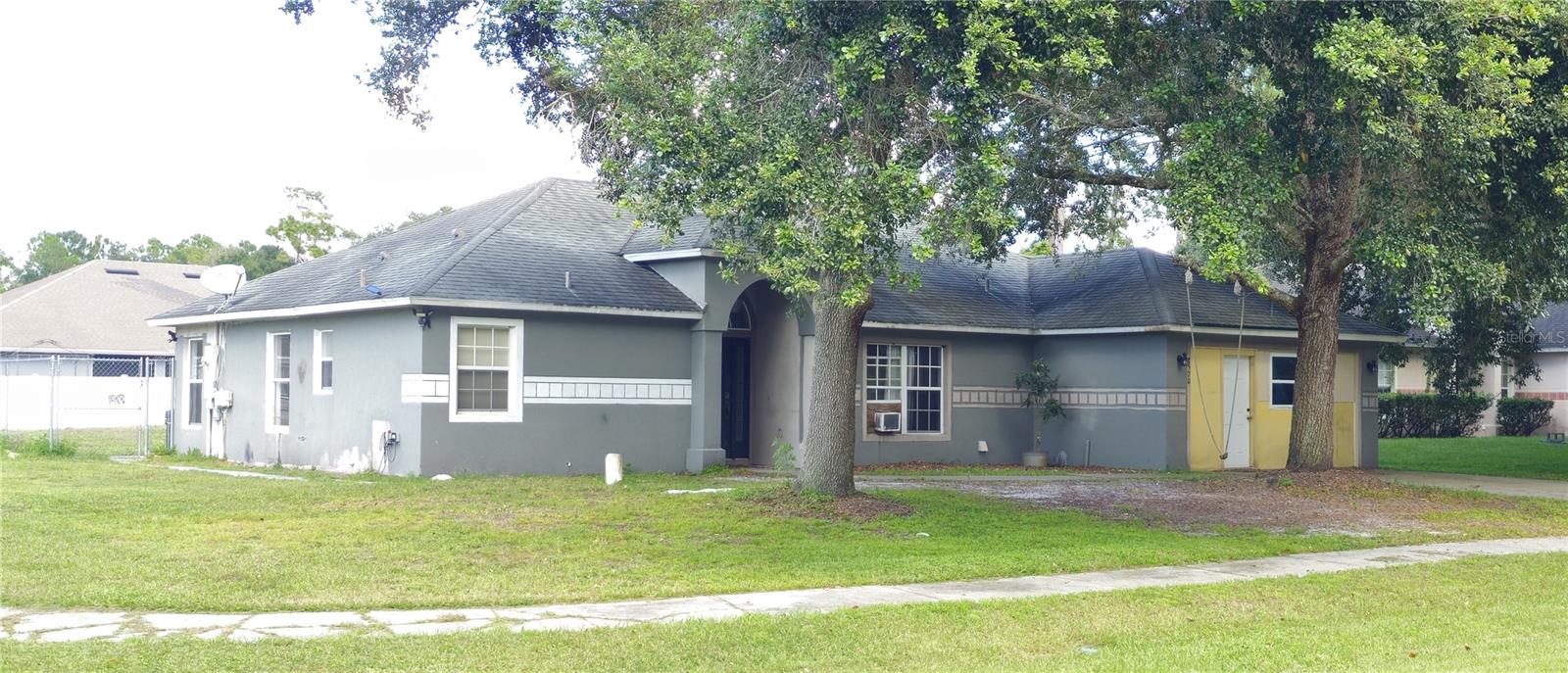 The possibilities are endless at this MULTI-GENERATIONAL home in Deltona! This home has been configured into 3 separate suites, perfect for income-generation, house-hacking, multi-generational living or conversion back to a more traditional home. All that's missing is the right touch and a little imagination. The garage has been converted into a studio suite with a kitchenette and a private entrance. A two-bedroom suite complete with full kitchen and living room has been created on one side of the house. The core of the home contains a large family room, owner's suite, full kitchen and laundry room. An enormous garage/workshop sits at the back of the property ready to serve multi-purposes. A smaller storage shed belonging to the property sits conveniently on the west side of the property. This property is priced well below market to accommodate updates and repairs that will bring it to it's full potential.