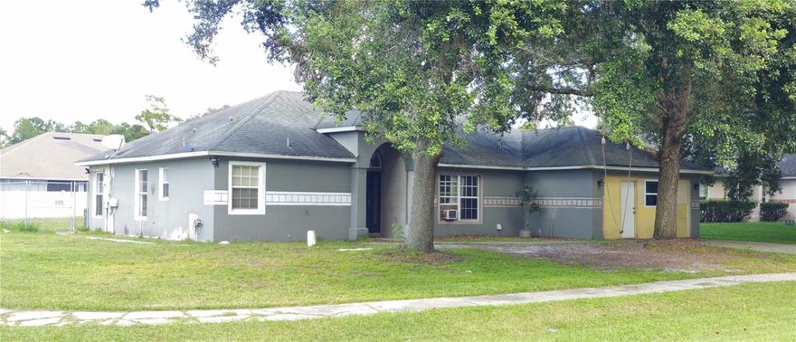 The possibilities are endless at this MULTI-GENERATIONAL home in Deltona! This home has been configured into 3 separate suites, perfect for income-generation, house-hacking, multi-generational living or conversion back to a more traditional home. All that's missing is the right touch and a little imagination. The garage has been converted into a studio suite with a kitchenette and a private entrance. A two-bedroom suite complete with full kitchen and living room has been created on one side of the house. The core of the home contains a large family room, owner's suite, full kitchen and laundry room. An enormous garage/workshop sits at the back of the property ready to serve multi-purposes. A smaller storage shed belonging to the property sits conveniently on the west side of the property. This property is priced well below market to accommodate updates and repairs that will bring it to it's full potential.