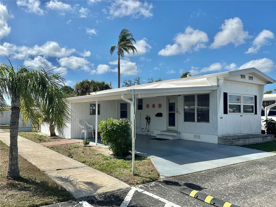 MOTIVATED SELLER SAYS BRING AN OFFER!  NO LOT RENT HERE, LOW HOA FEE & THE SHARE IS INCLUDED IN THE PURCHASE PRICE!!!  Beautifully updated home located in the desirable Bradenton Tropical Palms, a gated 55+ community in Bradenton. This light and bright residence features a subtle coastal vibe throughout, creating a relaxed and welcoming Florida home.

The thoughtfully updated interior offers comfortable living with an open feel and abundant natural light. Recent improvements include brand new water-proof flooring (including sub-floors) updated plumbing, electrical, five-year-old air-conditioning system and a roof that is only two years old, providing peace of mind for years to come.  The enclosed porch is under air and could easily be utilized as a secondary sleeping quarters/recreational area.

Situated in a private location within this golf cart-friendly community, the home enjoys the added benefit of having no direct rear neighbors, offering a more peaceful and private setting.

Bradenton Tropical Palms is a gated 55+ community known for its welcoming atmosphere and beautifully maintained grounds. Residents enjoy a variety of amenities and an active social calendar filled with events and gatherings. Community features include a large heated pool, indoor pickleball courts, shuffleboard courts, a pool hall, a library, and a large gymnasium with a stage. The recently updated community kitchen is ideal for hosting parties, club meetings, and social gatherings with neighbors and friends. Conveniently located near shopping, dining, and medical facilities, the community is also just 10 miles from Sarasota-Bradenton International Airport and only 8 miles from the beautiful Gulf beaches.

Whether you're seeking a seasonal retreat or full-time Florida living, this charming home offers comfort, privacy, and the easy lifestyle you’ve been looking for.