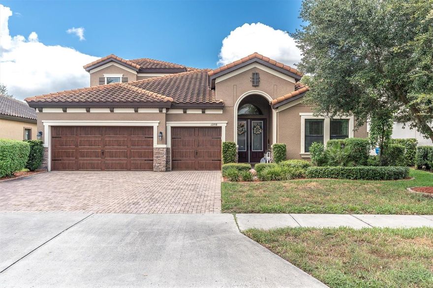 Step into luxury with this SHOWCASE HOME ON CONSERVATION in the highly sought-after Starkey Ranch! Built in 2018 by Homes by WestBay, this immaculate Bayshore II model sits on a private 65-foot conservation lot in Homestead Park and offers 4 bedrooms, 4 bathrooms, a 3-car garage, dedicated office, spacious bonus room, and a stunning stainless steel outdoor kitchen, perfect for alfresco entertaining. The Mediterranean-inspired exterior boasts a tile roof, stone accents, and paver driveway, while the interior impresses with soaring ceilings, arched architectural details, upgraded lighting, and rich wood-look tile flooring. The open-concept layout features a grand room with 16-foot disappearing sliders that showcase serene west-facing views, a generous dining area, and a gourmet kitchen with quartz countertops, custom cabinetry, GE Profile stainless steel appliances, and premium Moen and Delta faucets. The first-floor owner’s retreat offers tray ceilings, peaceful conservation views, and a spa-like ensuite with dual vanities, quartz counters, a sunken tub, frameless walk-in shower, and custom closet. Upstairs, the bonus room with full bath provides flexibility for a fifth bedroom or media space. Enjoy nightly sunsets from the large screened lanai overlooking the tranquil pond and lush greenery. Smart home upgrades include a water softener system, tankless water heater, and epoxy garage flooring. Starkey Ranch offers top-tier amenities: a K–8 magnet school, library, theater, three pools, playgrounds, dog parks, 20 miles of trails, a community garden, Cunningham Lake, and vibrant year-round events, all just minutes from Publix, dining, beaches, and an easy commute to Tampa. This home is the perfect blend of elegance, comfort, and convenience, schedule your private tour today!