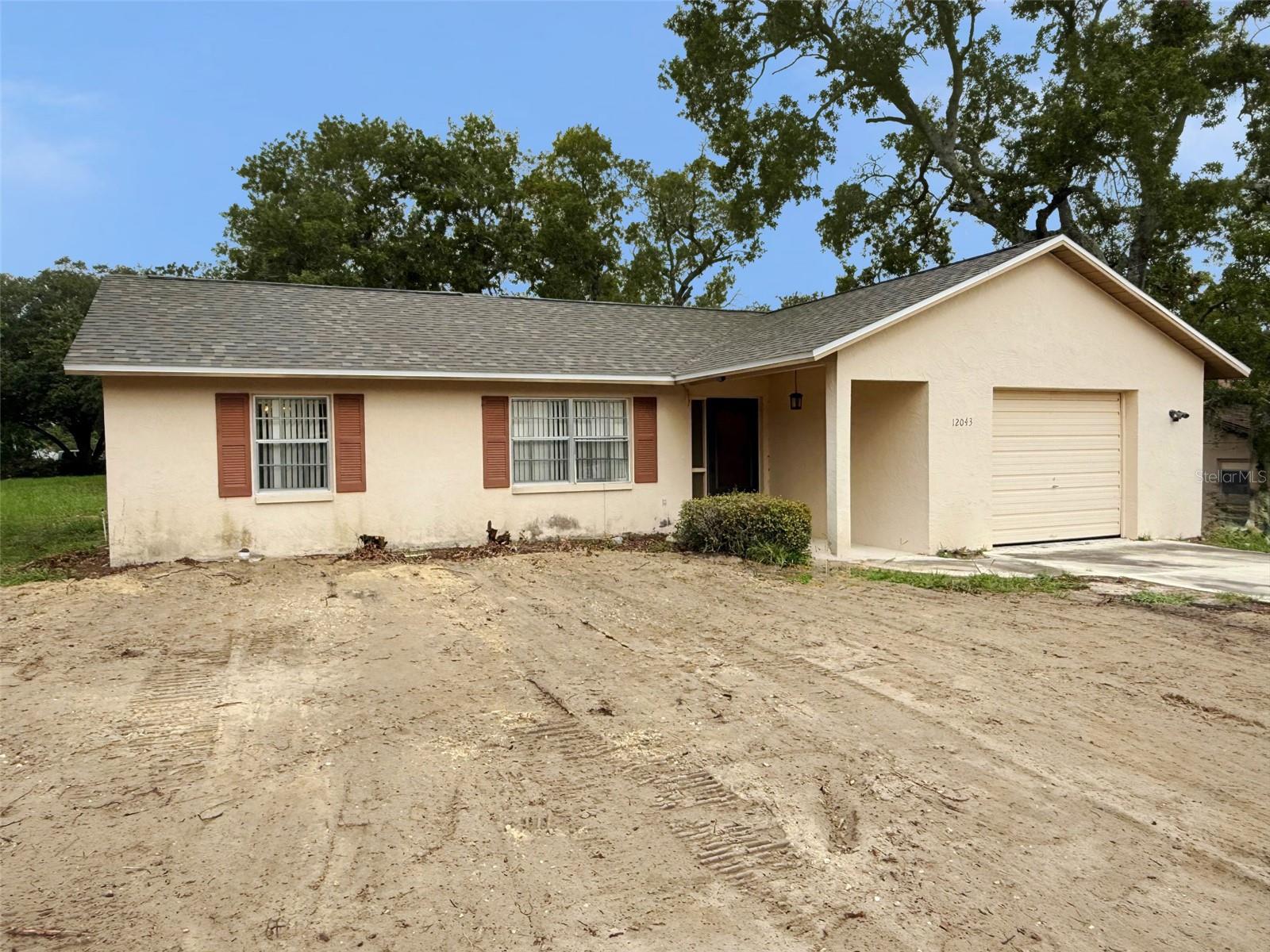 Welcome to this well-maintained 2 bedroom, 2 bathroom, 1 car garage home that offers peace of mind with several important big-ticket updates already completed. Featuring a brand new roof, new HVAC system, new water heater, and new septic, this home is ready to provide comfort, reliability, and value for years to come. Buyers will appreciate the investment already made in the essentials, allowing them to focus on making the home truly their own. Step inside to find a bright and inviting layout featuring a living room, dining area, galley style kitchen, den, and a split bedroom layout. The primary bedroom is generously sized and has an en-suite bathroom and walk-in closet. There's also an enclosed back porch that could easily be a 3rd bedroom or an office. All this and situated on an oversized, corner lot! This property is eligible under the First Look Initiative which expires after 30 full days on market. No investor offers until first look period expires. No offers regardless of buyer type will not be negotiated within the first 7 days of listing.