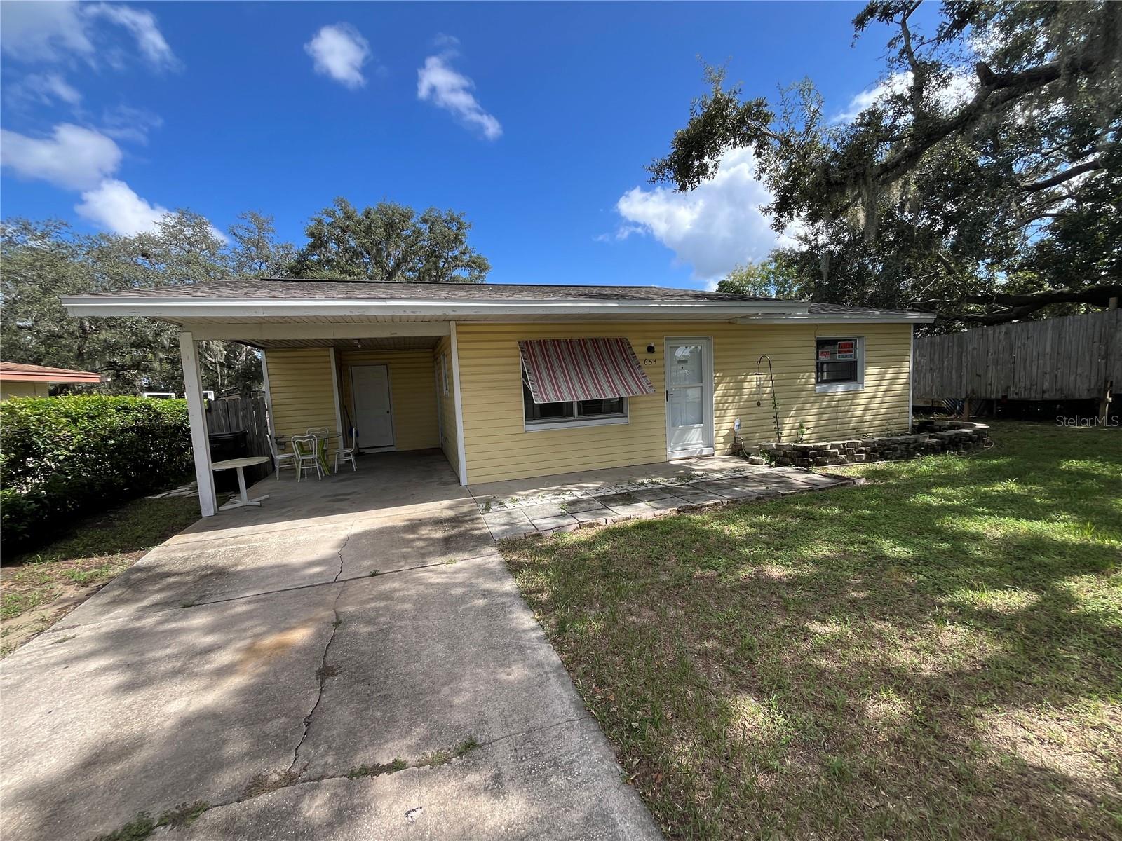 One or more photo(s) has been virtually staged. 2/1 HOUSE FOR RENT IN LAKE WALES, FL! Recently remodeled. Spacious kitchen with granite counter tops, microwave range hood, range and refrigerator. Updated bathroom toilet, tub and vanity. Wood laminate flooring through out. Large screened in back porch with tile floor. Large storage shed available to the tenant. Nice sized backyard that is partially fenced. Carport. Outside utility room with washer and dryer. Outside city limits. Centrally located, close to shopping. Make your appointment to see today!