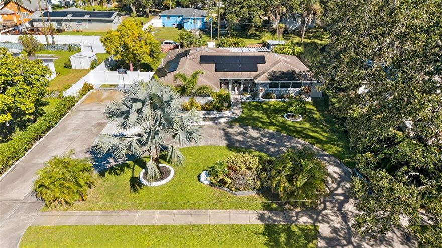 Sprawling rental home - FURNISHED - on a beautiful area of 26th Ave South. The approach into the property is highly impressionable with tall palm trees on 26th, and a long semicircle driveway accommodating up to six vehicles centered by tropical Bismarck palm. 2-car garage. Solar panels for LOW ELECTRICITY BILLS! Kitchen enthusiasts will appreciate this one with an abundance of custom cabinetry, granite countertops with integrated backsplash, and eat-in bar for grabbing a quick convenient bite. Two living rooms to which you can designate functionality as you wish with the main featuring an 85" Samsung OLED Smart TV. Front porch and back enclosed lanai with oversized fenced-in backyard. Terrific for any pups that would like to come along & enjoy the secure 10,000sf lot! Pet-friendly with Ring security system optionally available for your use. Located within a mile from Lake Maggiore & St. Pete County Club for terrific walkability. The combined indoor & outdoor utility of this home is hard to find, and the next tenant will be sure to enjoy! Nearly all furnishings pictured are included, but please inquire within for any exception requests or questions. Professionally managed.