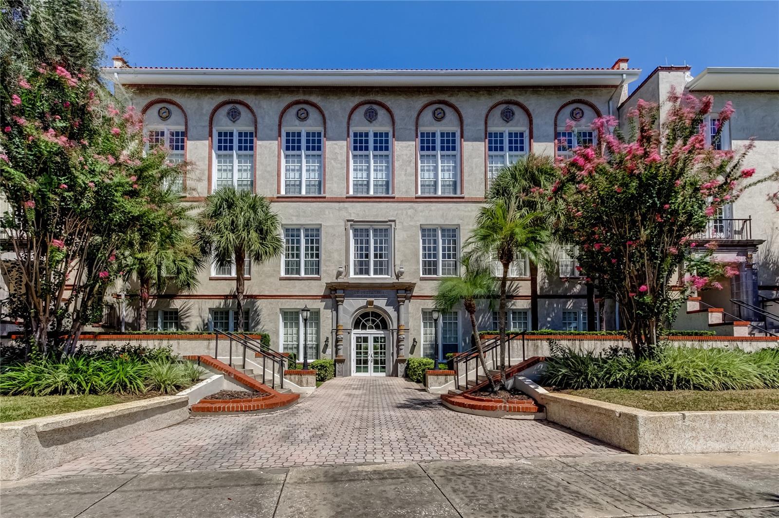 Historic High School conversion makes this condominium a treasure, not only the history but built so well it was used a designated fall out shelter, in the heart of St Petersburg, surrounded by museums, library, renowned shuffle board and lawn bowling. Across from the beautiful Mirror Lake and gorgeous new courthouse. Minutes to Restaurants, gyms, shopping and grocery stores. Lots of charm with modern convenience. First floor unit is so lucky to have high ceilings and windows just off the east side of the building.The newer AC unit ensures your comfort year-round, and the new thermostat allows you to easily control the climate. Natural light floods the living space through the impressive 10 ft. x 12 ft. windows, and impressive 20 ft ceilings add a sense of grandeur. This comfortably spacious condo with wood and Tile floors throughout. new Sprinkler system, freshly painted ceiling to floor. Walk in closet in a good size bedroom large enough for a king bed plus... updated bath and kitchen. Eat in kitchen, great room. Complex has pool, and courtyard. Laundry room is adjacent to this unit. But there is a w/d hookup in unit. Very convenient. Great reserves, strong foundation of finances. Unit never flooded or any part of building.