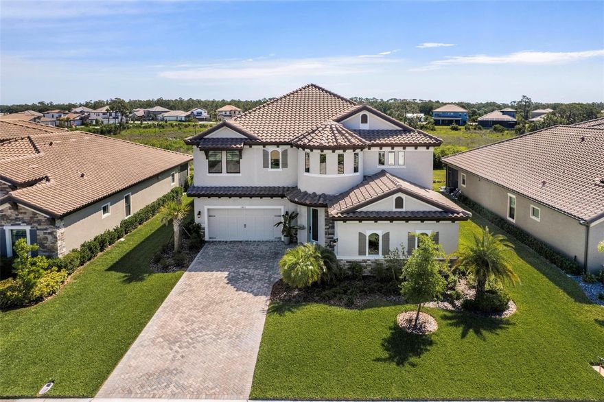 Motivated Seller Pricing (Competitively priced, offering over 4,200 sq. ft.) This 3 car, 5 bedroom, 4.5 bath home was designed to impress. With great attention to detail inside and out. This home features striking curb appeal with a rotunda front entry, ornate glass front door, tropical landscape and split garage design. The 2 story foyer welcomes you with a soaring double circular tray ceiling and amazing light fixture. Upon entering the oversized foyer you will see an office with glass doors, modern style dining room which leads the way to a luxurious gourmet kitchen, with expansive island, quartz countertops, and an upgraded table extension for even more seating. This kitchen features an abundance of 42" cabinets and drawer space, as well as under island cabinet storage. Pantry- walk in with frosted glass door. Kitchen appliances include a gas cooktop with vented hood, microwave with convection oven and upgraded refrigerator. The kitchen overlooks the grand family room. The family room has 8' sliders off the back which offers serene views of the preservation area. There is also a bedroom/guest suite on the first floor and full bath. Covered Lanai on first floor is rough plumbed and has a gas rough in for a future summer kitchen, fenced in backyard with room to add a pool. As you come up the eloquent stairway, the 2nd floor boasts the Owner's Retreat and opulent bath. The Owner's bath includes an oversized, free standing soaking tub, glass enclosed shower, with dual shower heads. One being a rain shower head and his and hers walk in closets. You will also find 3 more generous bedrooms and 2 full baths, one featuring a Jack and Jill style bath. This home also includes a sizable bonus room with rough in for wet bar and access to the 2nd floor screened in balcony, great for entertaining or drinking your morning coffee. A place where you can enjoy birdwatching and observe wildlife in the natural preserve in the rear yard. The Laundry room comes with a laundry sink. The washer, dryer are included in the sale. Crosswind Ranch offers a variety of amenities. Residents will enjoy a resort-style community pool, open-air cabana, pocket parks, and scenic water and conservation views. Further amenities include a community amenity center, pickleball courts and trails. Crosswind Ranch is conveniently located to top area schools, Tampa, St. Petersburg, Sarasota and the Gulf Coast's beautiful beaches. This home is even better in person! Popular Madeira III floor plan. Schedule your private tour today!!! (Seller is licensed real estate agent)