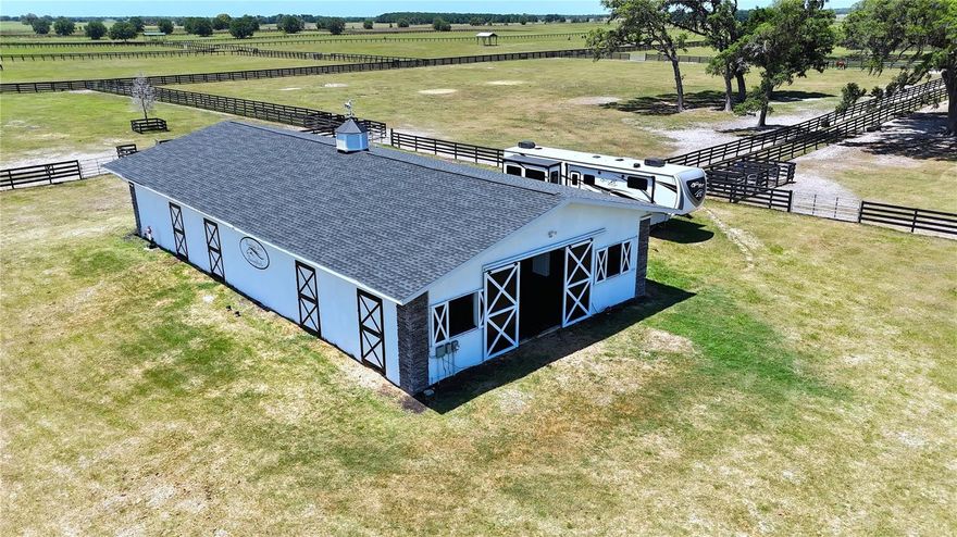 Premier 50± Acre Equestrian Farm | 7-Stall Barn | Optional 3,600 SF Emerald Model by Triple Crown Homes.

This exceptional 50± acre equestrian property is beautifully situated on a high and scenic elevation and is fully equipped for horses or cattle, offering an outstanding opportunity near the World Equestrian Center.
The property features a center-aisle concrete block barn with 7 matted stalls, each equipped with fans, lighting, and individual rear access doors. An efficiency apartment within the barn includes a full bath, laundry area, and break space—ideal for staff or on-site management. Additional barn amenities include a wash area, center feed room, storage room, and mechanical room, all thoughtfully designed for functionality and ease of operation.
A secondary barn provides two foaling stalls and hay storage, while the farm is fully perimeter fenced and divided into 12 paddocks, ready for immediate use.  A round pen and 50-amp RV hookup further enhance the property’s versatility.  
A 3,600 SF Emerald model residence by Triple Crown Homes is available to be built, offering a 3-bedroom, 2-bath layout consistent with the Emerald model currently showcased by the builder. Details regarding construction and finishes are available upon request.
The current price reflects the value of the land, the exquisite residence, and the exceptional equestrian facilities, presenting a unique opportunity to embrace a lifestyle of elegance and charm.  Conveniently located approximately 9± miles from the World Equestrian Center.