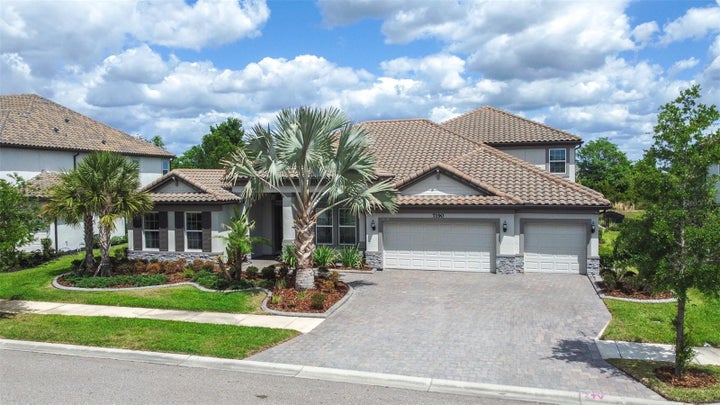Mature Landscaping and Barrel-Tile Roof Accent the Exterior of the Home