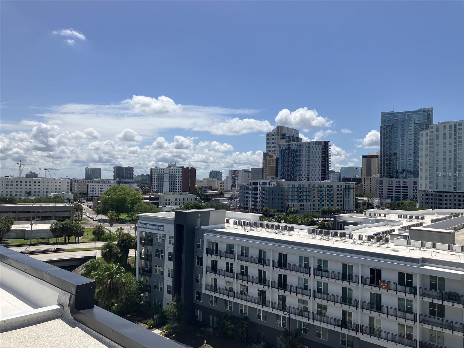 Don't miss this unique downtown penthouse with a private rooftop terrace and dedicated one-car garage! One Laurel Place is ideally located in the Tampa Arts District, just steps away from the award-winning Tampa Riverwalk. This nearly 3-mile walking/jogging path offers restaurants, waterfront parks, dog parks, art museums, the Straz Performing Arts Center, and Armature Works. This 2-bedroom, 2-bath open-floorplan condo features a kitchen with granite countertops, an island with a breakfast bar, ample cabinet space, and a pantry. The massive combination living/dining room has a balcony off the great room, providing city views and an abundance of natural light. The sizable primary bedroom, accessed through French doors, is complete with an ensuite bath and walk-in closet. A second bedroom and bath round out the main floor. Up the spiral staircase awaits your private oasis: a rooftop terrace with spectacular 360-degree views of the city skyline and Hillsborough River. Perfect for entertaining or simply relaxing in solitude. The unit comes with a private one-car garage, providing a guaranteed covered parking space and additional storage. The building features a gated entrance with 24-hour monitoring, a pool and spa, and a community courtyard with grills.