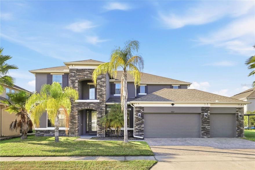 Come take a look at this stunning home in the desirable Woodland Park subdivision. Upon first approach, you'll notice the massive curb appeal, as this is a premium lot, and your eyes are first drawn to the beautiful stack stone front porch. Its original and only owners
have put so much love and care into this beauty, and it really showcases their pride in ownership throughout. Not only does this well thought out 4 Bedroom, 3.5 Bathroom, 3 car garage Taylor Morrison home have a separate Flex Room/Office, it also has a dedicated theater room that can be used as a fifth bedroom as well as many lavish upgrades throughout the entire property. Some of the interior upgrades include speakers in the ceiling of the interior and lanai, Cat6 pre-wire, decorative lighting in all rooms, open hand rail, and no carpet throughout the home. Upon entering, you'll feel the grand, open, bright, and welcoming atmosphere that draws your eyes to the intricate custom tile entertainment wall. Natural light pours throughout the main living area, and with no neighbors behind, you can enjoy the relaxing pond and preserve views. The gourmet eat-in kitchen features stainless steel appliances, built in double oven, unique quartz countertops, upgraded backsplash, gas cooking, and 42" upper solid wood full overlay cabinets, complete with crown molding. The beautiful owner's suite is generously sized and includes an adjacent sitting room with a custom stone wall. The spa-like primary bath, features a soaker tub and separate oversized shower surround. Downstairs also features a flex room/office with French doors, as well as formal living and dining rooms, a half guest bath, and the laundry room. Heading upstairs, you'll take notice of the hardwood treads and wrought iron pickets that make a stunning focal point from the main areas of the home. Once upstairs, you will find a huge living area/game room also featuring beautifully engineered hardwood floors. The second bedroom, with a full bath conveniently located next door, faces a pond and preserve for amazing views. The two other bedrooms and full bathroom are across the bridge and balcony. The theater room is located right next to the living area/game room, away from the bedrooms. Heading outside, exterior luxuries that help make the perfect atmosphere for entertaining include a beautiful covered screened-in lanai and a vent hood above the space dedicated to your outdoor kitchen which is already a pre-plumbed sink area. The outdoor living area looks out to a well manicured yard that flows seamlessly into a stunning view of the pond and preserve. Woodland Park offers a community pavilion, pool, playgrounds, a multipurpose field, dog park and scenic conservation areas. Location includes close proximity to Orlando International Airport, a 30 min drive to Orlando's Restaurant Row for dining and shopping. Theme parks, attractions, downtown Orlando and ample entertainment and much more!