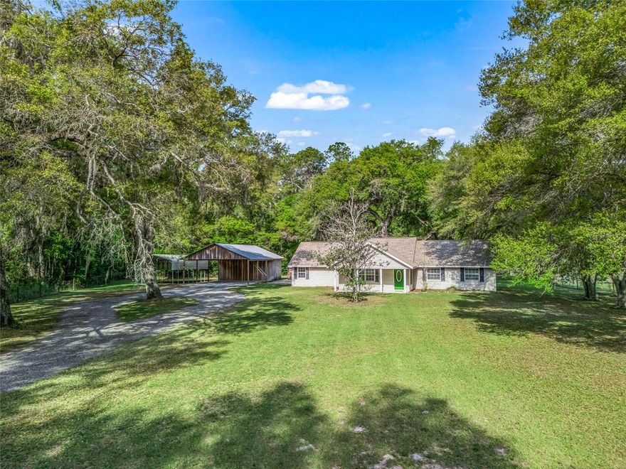 NO HOA!! LOCATION LOCATION!! Experience the charm of country living on this beautiful 6.81 acre property, ideally situated on a spacious corner lot shaded by stunning oak trees. This 4-bedroom, 3-bath totally remodel home is set back off the road, offering privacy, tranquility, and that true rural atmosphere buyers are looking for.
Inside, you’ll find a warm and inviting wood-burning fireplace perfect for those cooler evening and a comfortable, functional layout designed for everyday living. This home features two primary bedrooms, each with its own private bathroom, offering flexibility for multi-generational living or guest accommodations. The kitchen includes a brand-new refrigerator, with all other appliances approximately 5 years old or newer. Major updates include a new roof (2024) and two water heaters (2024 & 2022). The A/C system is approximately 10 years old.
Step outside to the large screened-in back porch an ideal place to relax and take in the peaceful surroundings.
This property is set up and ready for your animals! Bring the horses, cows, and all your toys there’s a separate pasture area with two stalls already in place. The impressive 30x80 pole barn with loft and attached workshop (with electric) offers endless possibilities and could easily function as a feed room, hay storage, or tack room. You’ll also appreciate the covered RV/boat parking, making this property as functional as it is beautiful.
The west and south sides of the property are lined with trees, creating a private, secluded setting where you can enjoy nature and frequent wildlife including wild turkeys roaming the land.
Whether you’re looking for a mini farm, a place to spread out, or simply enjoy the quiet country lifestyle this property offers endless possibilities. Very convenient to local grocery stores and restaurants. Easy commute to I-75 which goes to Tampa, Ocala and the turnpike. Call today for appointment.
