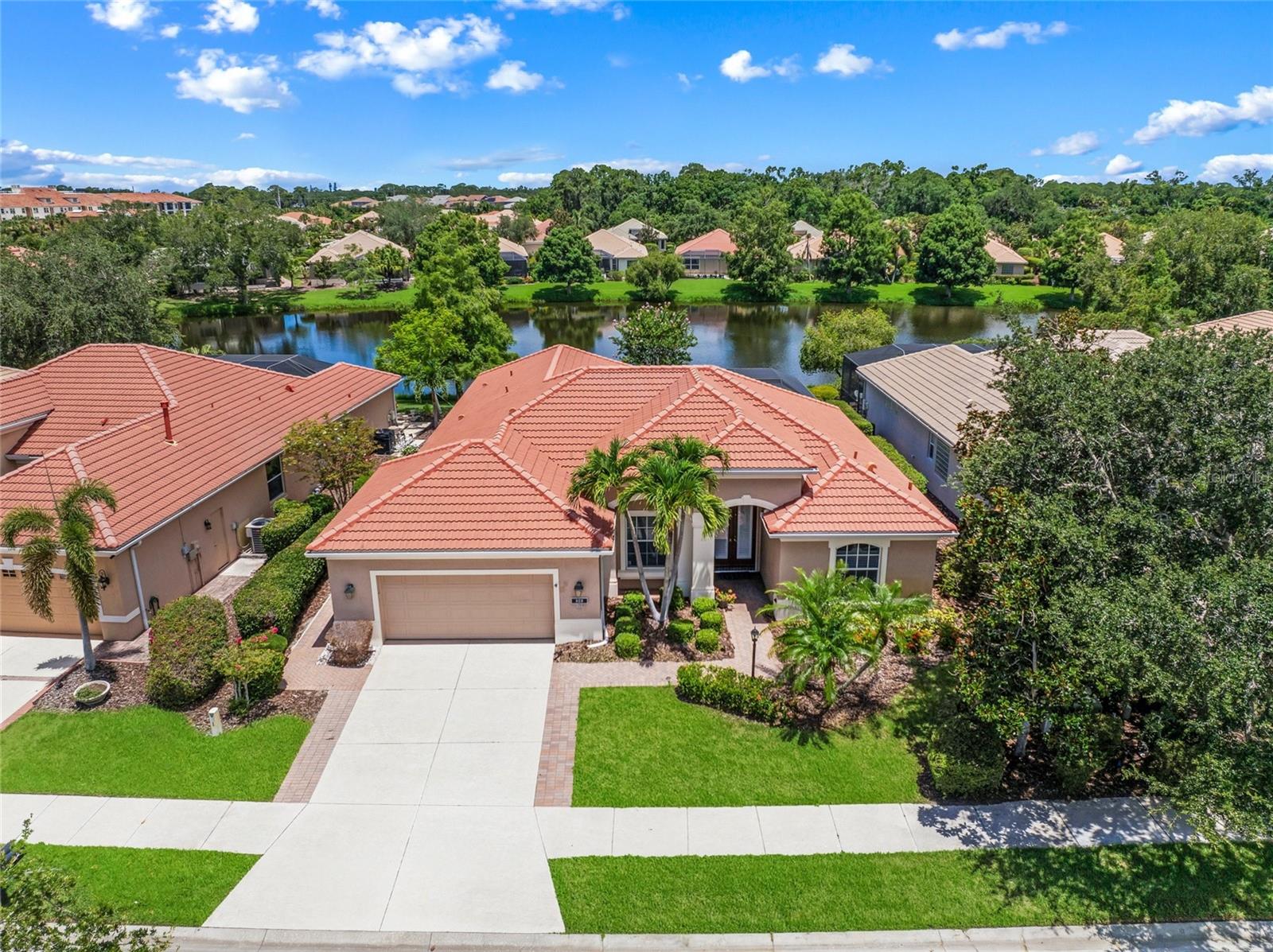 In the Lee Wetherington built community of Willowbend is a stunning home. This enchanting residence is bordering a sparkling lake with curb appeal emphasized by lush landscaping and a paver accented driveway. This quality-built home is the desirable Ashley II floor plan, with an oversized 23-by-19 garage. Every detail in this home is addressed with remarkable style including double-door entry, vaulted tray ceilings, crown molding, plantation shutters and many built-in features. The kitchen is spacious in design with wood cabinetry, a center island, kitchen desk and granite counters. The kitchen dining area has wide open views through an aquarium window. Formal dining room has a granite topped built in buffet, framed by an arched wall. The family room has a double tray ceiling with corner pocket sliding doors. Owner’s suite features wood flooring, walk-in closets and a luxurious bath with dual sinks, a garden tub, a walk-in shower plus direct pool and lanai access. Three bedrooms on the opposite side boast large closets, two with private pocket door access and bath, the fourth bedroom also has a bath serving as a pool bath. Two of the bedrooms have extensive built-in shelving and desks. It’s always about the view and you will enjoy the privacy of a large lanai with a heated pool. Nothing captures the mood better than serene living with a menagerie of birds and wildlife. On a practical side, home has hurricane protection, AC replaced in 2018. Near top-rated Pine View School, Legacy Trail, restaurants, beaches, Intracoastal Waterway, boat and kayak launches, Publix, plus coffee shop, gym, pilates and more. For those who seek an exceptional waterfront lifestyle, nothing compares. Low HOA fees include maintenance of yard, irrigation water, community pool/spa, high speed internet, cable TV, gym and pickle ball court. While a short distance from the Intracoastal and Gulf of Mexico, this home is in a preferred X flood zone.