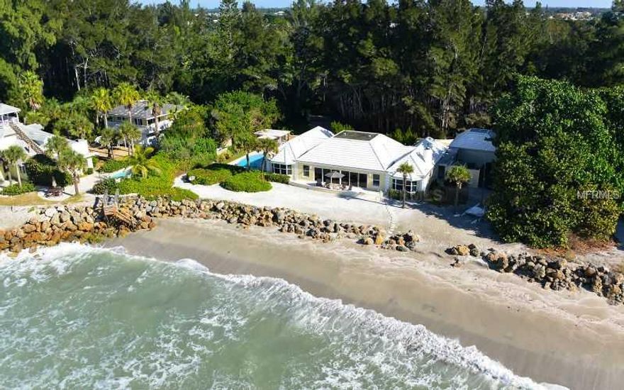 Truly one of the Gulf front jewels of The Sanderling Club!  With unparalleled views of the azure blue Gulf from almost every room, this casually elegant beach house was beautifully and tastefully remodeled in 2008 with the addition of new granite and stainless kitchen, travertine floors, new baths, new electrical & plumbing, tile roof, impact windows and doors, generator and much more. Rooms were reconfigured to create open spaces for gracious entertaining. The oversized living and dining room feature higher ceilings, crown molding, recessed lighting, wet bar and built-in storage. A light-filled family room with fireplace adjoins the gourmet kitchen with island. Master and guest rooms are en suite. A beautiful pool (recently re-marcited and new pump) is surrounded by a pavered patio and charming gazebo for outdoor entertaining. The walk-out beach offers protection with a permitted hardened shore. The spacious .8 acre lot allows for an addition to the existing house or a sizable buildable footprint for new construction. The Sanderling Club is a gated, private Gulf front community of only 100 homes on estate-sized lots.  Amenities include 24 hour security, Paul Rudolph-designed cabanas & beach house, 3 tennis courts (one Har-Tru), private beach & a marina with bay access. Nearby is award-winning Siesta Key Beach and Sarasota, with its restaurants, shopping and cultural attractions, including its own opera, ballet company and orchestra.