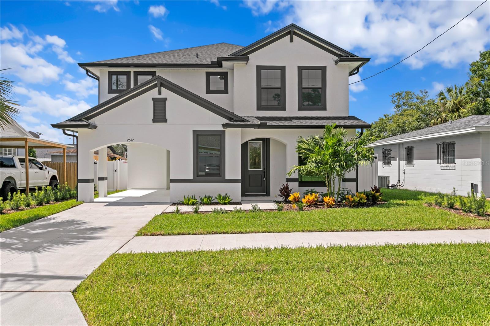 Welcome to 2512 W Kathleen Street, a meticulously designed Craftsman Style 4-bedroom, 2.5-bathroom residence offering 2,322 square feet of refined living space, crafted in 2025 by Ciro & Ciro Homes. From the moment you arrive, the home’s curb appeal captivates with its welcoming covered front porch, manicured landscaping, and timeless architecture. Step inside to discover a light-filled and airy open-concept floor plan, where 9’4” ceilings, expansive windows, and luxury vinyl plank flooring set the tone for elevated everyday living. The front of the home opens into a generous formal living room, flowing effortlessly into a spacious family room — the perfect setting for casual lounging or entertaining. Anchoring the main level is a stunning chef’s kitchen featuring elegant 42” soft-close maple cabinetry, quartz countertops, a large finished wood island, Whirlpool® stainless steel appliances, a decorative tile backsplash, built-in trash pullout, and ample space for both meal prep and gathering. Glass sliders from the kitchen extend your living area outdoors to a covered rear porch, overlooking a fully enclosed vinyl-fenced backyard — ideal for outdoor dining, gardening, or enjoying the Florida sunshine in privacy. Upstairs, a large loft area provides flexible space for a media room, playroom, or second lounge. The private primary suite is thoughtfully positioned on one side of the home, creating a peaceful retreat complete with a spa-inspired bathroom that includes a frameless glass walk-in shower, dual elevated vanities, quartz surfaces, Moen® chrome finishes, and a spacious walk-in closet. Three additional upstairs bedrooms offer generous layouts and closet space, ideal for guests, family members, or home offices, and are conveniently located near the upstairs laundry room for added efficiency. Every detail of this home has been designed for modern comfort and lasting quality — including dual-zoned HVAC, smart home wiring, a full security system, and a built-in pest control system. Outside, a covered carport with an attached storage closet provides convenient parking and organization solutions. Backed by Maverick Builder Warranty 1-2-10, this home offers not only style and substance but also peace of mind. Situated in a prime central Tampa location, just minutes from Midtown, Raymond James Stadium, Tampa International Airport, and the vibrant downtown core, this property is a rare opportunity to own brand-new construction with thoughtful design and lasting value in an established neighborhood.