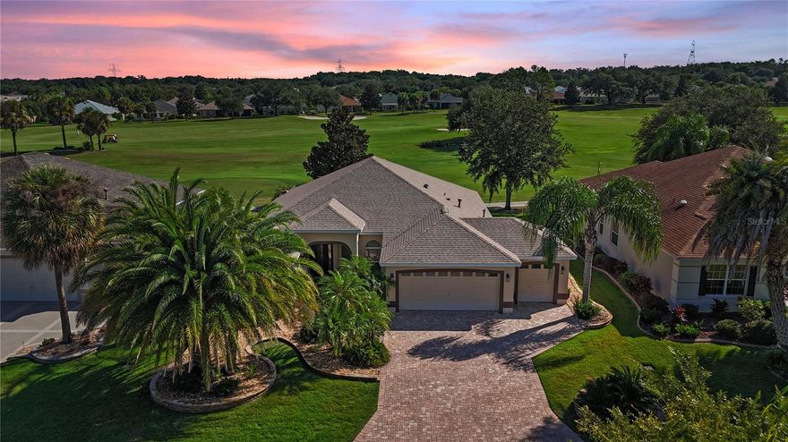 Spectacular Designer Home, the popular Gardenia model with breathtaking golf course views.  Located directly on the 5th Fairway of the Caroline Golf Course with sweeping Double Fairway Views! NO BOND!!! This beautifully maintained home features a golf cart garage, a new Roof (2021), A/C (2017), and elegant upgrades throughout including 19” ceramic tile flooring, crown molding, and 5” baseboards. The gourmet kitchen is highlighted with granite countertops, newer stainless steel appliances—including a 2-door/2-drawer refrigerator, large microwave oven, range, and dishwasher—perfect for the chef at heart. The spacious primary suite offers a Roman shower, private water closet, and granite dual vanities. Enjoy true Florida living with an expanded outdoor oasis, featuring a covered lanai with summer kitchen and an additional birdcage enclosure, perfect for entertaining while overlooking the golf course. Just a short walk to the mail station, adult pool, and shuffleboard, or a quick car or golf cart ride to the family pool at Captiva Cay Recreation Center. Only 10 minutes by golf cart to Lake Sumter Landing where you’ll find shopping, groceries, dining, and nightly entertainment. A 2017 Yamaha golf cart is included, making this the complete Villages lifestyle package!