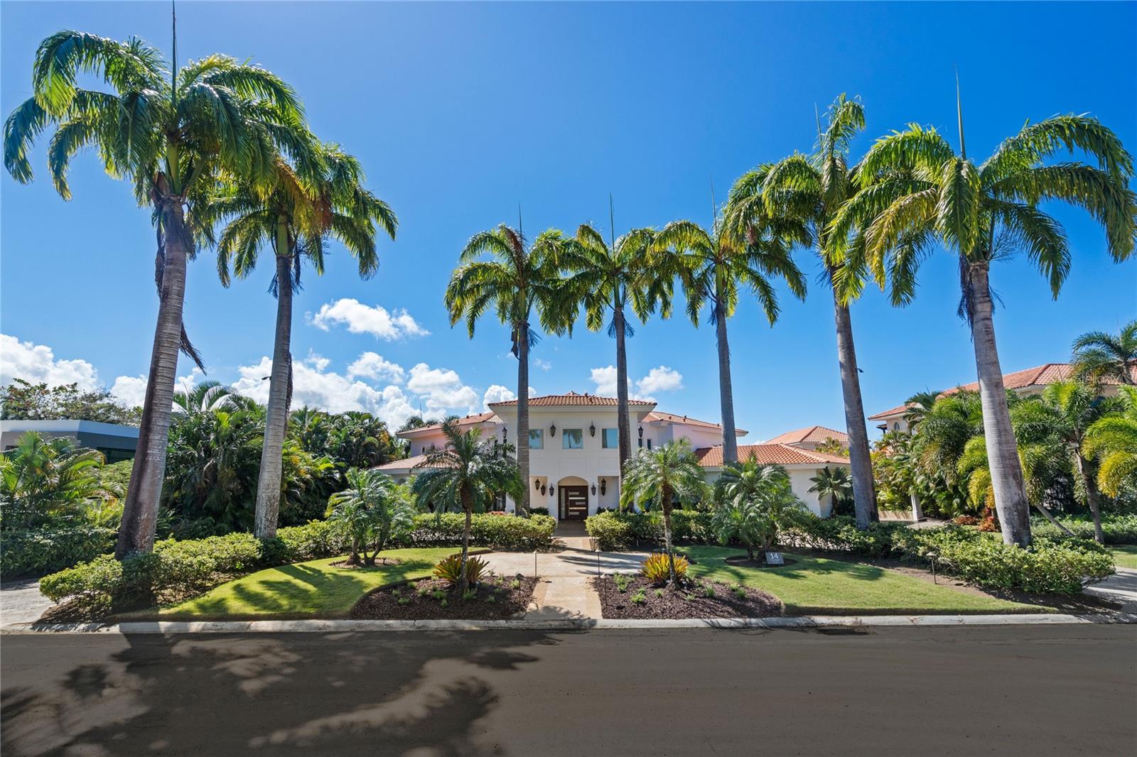 Welcome to your dream home at Dorado Country Estates, a private community offering large lots and a convenient location with just 64 lots, this neighborhood provides the perfect balance of luxury and tranquility, nestled adjacent to Dorado Beach Resort.
This custom-built property is situated on a sprawling 3,054 sqmt lot with views of the new West TPC Course at Dorado Beach Resort. Boasting approximately of 7,000 sq. ft. of indoor/outdoor space, the home offers a harmonious blend of elegance and modern comfort, perfect for both relaxing and entertaining. It features four spacious bedrooms, including a junior suite on the first floor and three additional bedrooms on the second floor. The master suite is exceptionally ample, featuring two large closets, a big bathroom with a soaking bathtub, and direct access to the second-floor balcony, offering views of the golf course. The home also includes a versatile room currently used as a gym, which can easily be adapted to suit other purposes such as a playroom, hobby space, or additional office. There is also a dedicated office space and a private movie theatre, providing ample room for convenience and entertainment. There are seven fully renovated bathrooms and two powder rooms to accommodate the needs of a modern lifestyle.
Upon entering, you are greeted by a grand entrance with double-height ceilings and a skylight that fills the home with natural light, creating an inviting atmosphere. The fully renovated kitchen showcases a sleek, all-white design with ample storage and cooking space, perfect for culinary enthusiasts. Outdoors, a generous terrace with a sparkling pool and a gazebo area with a BBQ and a bar provides the perfect setting for hosting gatherings or unwinding in style. The second-floor balcony offers serene views of the golf course, serving as a peaceful retreat for morning coffee and evening relaxation. Residence comes with a power generator that runs the entire house and a 1,000 gallon water cistern.