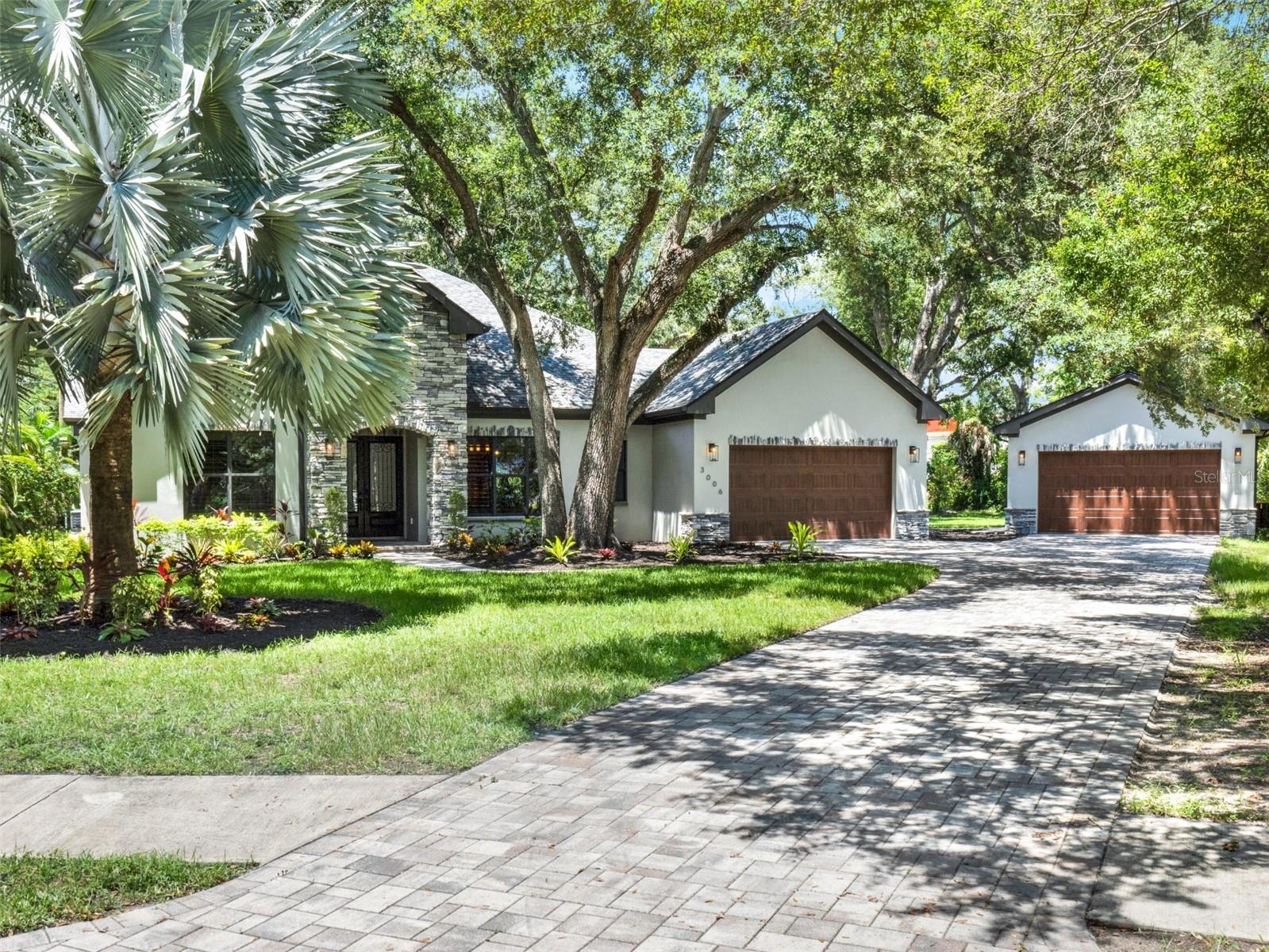 MOVE IN READY and ZERO DAMAGE from recent hurricanes. Discover the exceptional construction and forward-thinking use of space in this meticulously crafted 2019 estate, on a rare half-acre lot in Sunset Park. The sprawling architectural design offers over 4,300 square feet of living space, combining timeless elegance with modern comfort.
Gourmet kitchen, 10-foot center island, seamless stone countertops, custom cabinetry, top-of-the-line Thermador Professional Series appliances, massive Electrolux 32 inch refrigerator and freezer.
All bedrooms conveniently located on the ground floor for easy accessibility. No shared bedroom walls for maximum privacy. Luxurious primary suite with marble bathroom floors, dual vanities, freestanding tub, oversized private shower with three zones and 6-ft relaxation bench. Two generously sized secondary bedrooms, formal dining room and office that can serve as 4th bedroom. Versatile bonus room - ready to be your private cinema, custom closet/glam room, gym, wine cellar, podcast studio or home business. An additional finished 800 square feet upstairs, that can be converted into an in-law suite, with plumbing already connected.
Unmatched Quality and technology. Wide plank engineered hardwood and premium stone flooring. Plantation shutters and motorized blackout shades for light control. Integrated high tech Control4 smart home system for full control of audio, climate, lighting, and security cameras.
Oversized 10,000 square foot backyard perfect for future expansion that can accommodate a detached guest house, resort style pool, outdoor kitchen, cabana or anything else desired. Dual garages: Attached 2-car and detached 2-car with insulated doors and attic space. Over 3,800 square feet of decorative pavers for walkways and driveways. Double pane, low-E tinted windows.
Schedule your private tour today.