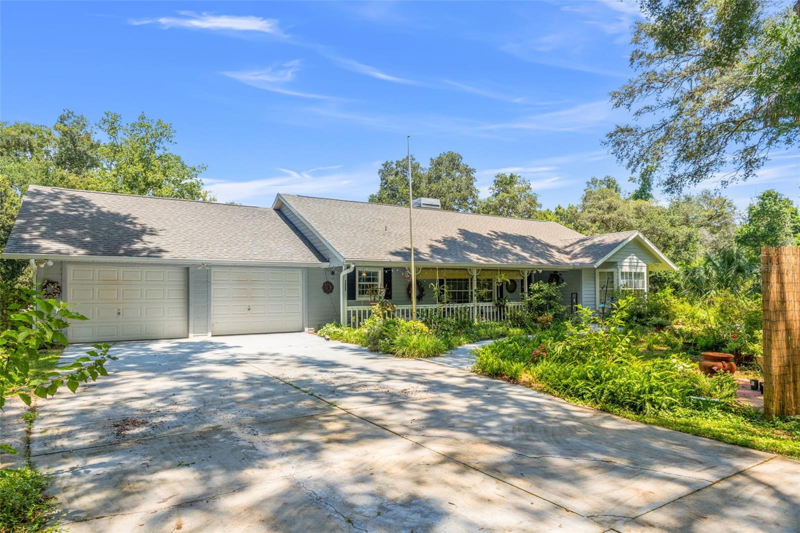 Welcome to your private country estate in the heart of Floral City, where the charm of Old Florida meets the convenience of modern living. Set on 3.85 acres of serene, wooded land with majestic live oaks and abundant wildlife, this property offers the perfect balance of privacy, natural beauty, and functionality. Regular sightings of wild turkeys, owls, and deer create a setting that feels like a nature preserve, yet you’re just minutes from local restaurants, museums, and the 47-mile Withlacoochee State Trail—one of Florida’s longest paved rail-trails. The main residence features approximately 2,424 square feet of air-conditioned living space, including an enclosed Florida room. Eucalyptus wood flooring flows through most of the home, complementing the wood stove that adds warmth on cooler days. The kitchen and baths have been thoughtfully updated, while the bedrooms are generously sized with ample storage. Major systems are already in place, with a roof replacement in 2015 and a complete AC change-out in 2016. Step outside to a peaceful, private swimming pool and a covered front porch perfect for morning coffee as you watch the birds and wildlife. Five mature lemon trees add a touch of Old Florida flavor to your property, while the garage offers plenty of workspace and storage. Whether you need room for RVs, boats, side-by-sides, or even horses, goats, and chickens, this land provides endless possibilities. City water is available along Stage Coach Trail, and Spectrum internet makes working from home easy. Adding to the appeal, this location places you within easy reach of Florida’s best outdoor recreation. Nearby lakes, rivers, and natural springs invite fishing, kayaking, and boating, while quick access to the Gulf of Mexico makes scalloping and saltwater adventures part of everyday life. Floral City is a community that has preserved its Old Florida character while still offering modern conveniences like parks with disc golf, nearby shopping, and dining. With no rear neighbors and two adjoining lots available for purchase, this property offers a rare combination of space, seclusion, and lifestyle. This home has been loved and well maintained, ready for its next chapter. Schedule your showing today and experience the true essence of Florida living.