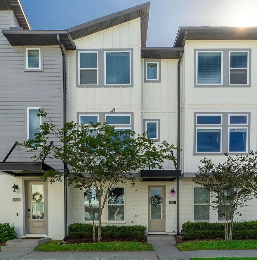This beautifully designed townhouse features three bedrooms, three full bathrooms, and one half-bath. The first floor welcomes you with a private bedroom, complete with a walk-in closet and en-suite bathroom for added privacy. On the second floor, the expansive open-concept layout unites the kitchen, dining area, and family room. The kitchen features an impressive 11.5 ft island with luxurious quartz countertops. The dining area extends to a private balcony, ideal for enjoying the beautiful surroundings of Laureate Park. A conveniently located half-bathroom near the stairs is perfect for guests. The third level features an extra guest bedroom with en-suite bathroom. Down the hallway, the primary suite serves as a personal sanctuary, featuring a generous walk-in closet and a glamorous primary bathroom with dual vanities, and toilet room. Conveniently located on the third floor, next to the primary suite, is the laundry room. This spectacular townhouse is situated in Laureate Park in Lake Nona, this exceptional neighborhood offers a wealth of amenities, including a refreshing 3 pool aquatic center, a fully-equipped gym, picturesque walking trails, and tranquil parks. The home is also conveniently located near Orlando International Airport, Medical City, and the USTA National Campus.