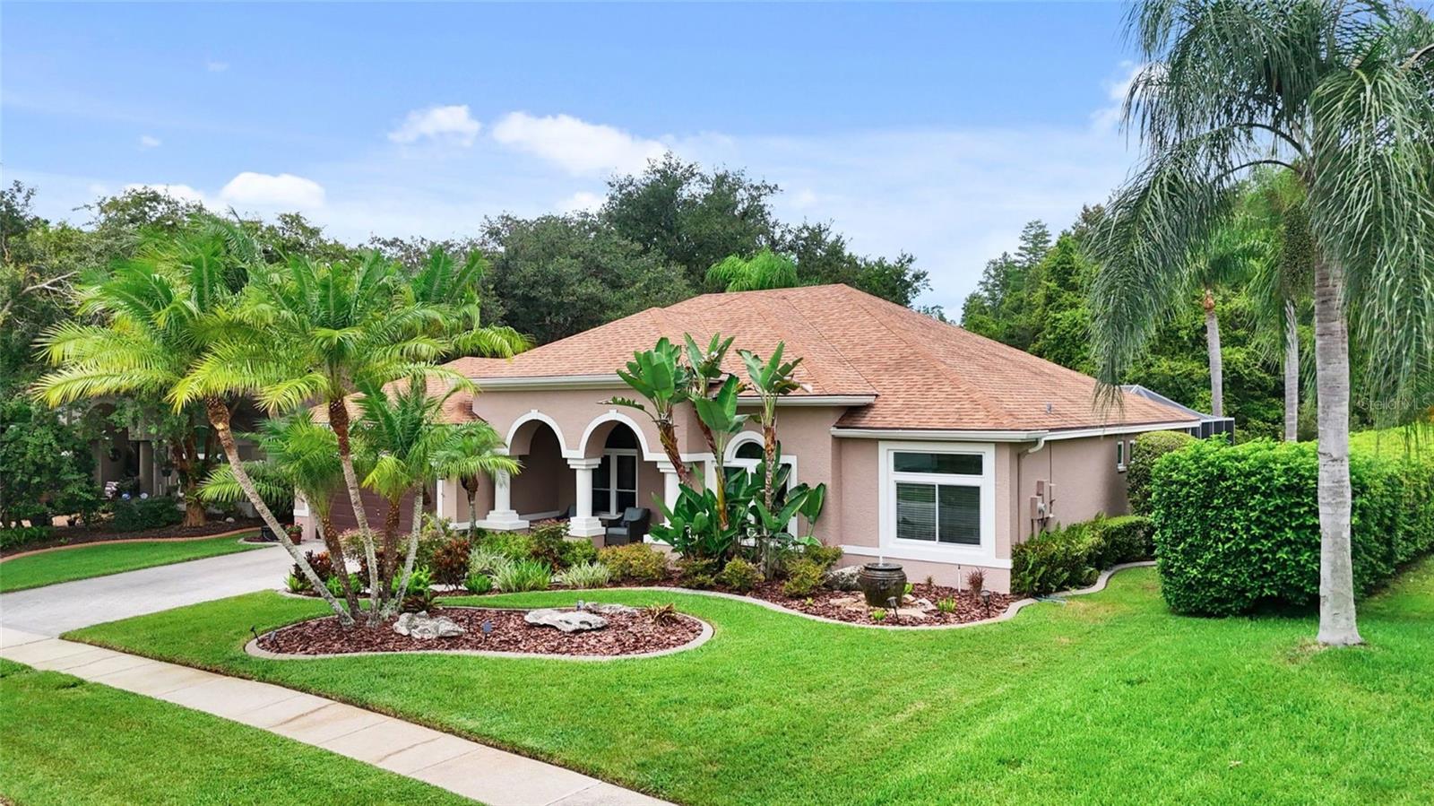 Experience refined Florida living at 6125 Savoy Circle, nestled within the renowned gated community of Cheval, where luxury, comfort, and thoughtful design come together beautifully. This move-in-ready pool home is zoned for some of the area’s most sought-after schools all just minutes away, making it ideal for families prioritizing both lifestyle and education. Step inside 2,143 square feet of bright, open-concept living space, where every detail has been upgraded for comfort and peace of mind. Featuring 3 spacious bedrooms, 2 fully remodeled bathrooms, and a 2-car garage, this home is impressive from the moment you enter. Every window and sliding door have been replaced with Viwinco hurricane impact glass (2022, $60K investment), ensuring safety and energy efficiency. You’ll love the soaring ceilings and the natural light that pours in, highlighting every exquisite detail from the hardwood floors to the sleek modern finishes. The heart of the home is the kitchen, a true chef’s dream completed in 2022 ($65K). Outfitted with 42” soft-close cabinetry, quartz countertops, a Bosch induction cooktop, and a massive island with built-in storage and pull-out trash/recycling, it offers elegance and practicality in equal measure. The adjacent family room with 5” Bengali hardwood floors (2022, $18K) flows effortlessly into the screened lanai, where your private pool awaits, resurfaced and resealed in 2021 ($8K) and updated with a saltwater system in 2022. Whether you're enjoying a morning coffee or hosting an evening gathering, the outdoor living space was made for Florida’s sunshine lifestyle. Retreat to the extremely spacious primary suite, thoughtfully designed to feel like a private oasis. The layout moves seamlessly from the sleeping area on toward the spa-inspired ensuite featuring a double sink quartz vanity, freestanding tub, private water closet and a frameless walk-in shower. The secondary bedrooms are well-sized with ample closet space, and the second bathroom has also been completely updated down to the studs (2020–2022, $73K total for both baths), ensuring every corner of the home reflects the same level of craftsmanship. Function meets style in the upgraded laundry room (2022), with new cabinetry, quartz countertops, and plenty of room to fold and organize. A new Rainbird sprinkler system (2022) ensures the meticulously landscaped lawn stays vibrant year-round. The home has been immaculately maintained inside and out, with the roof, gutters, and soffits recently soft-washed in July 2025 with a transferable 3-year roof cleaning warranty in place. Conveniently located just minutes from the Veterans Expressway and N Dale Mabry Highway, Cheval residents enjoy easy access to downtown Tampa, Tampa International Airport, and the area’s best destinations. Spend weekends exploring the nearby TPC Tampa Bay golf course and dining at top-rated restaurants. All the major updates have already been completed, just move in and enjoy the upscale Cheval lifestyle with confidence, comfort, and endless Florida sunshine. This home truly checks every box.